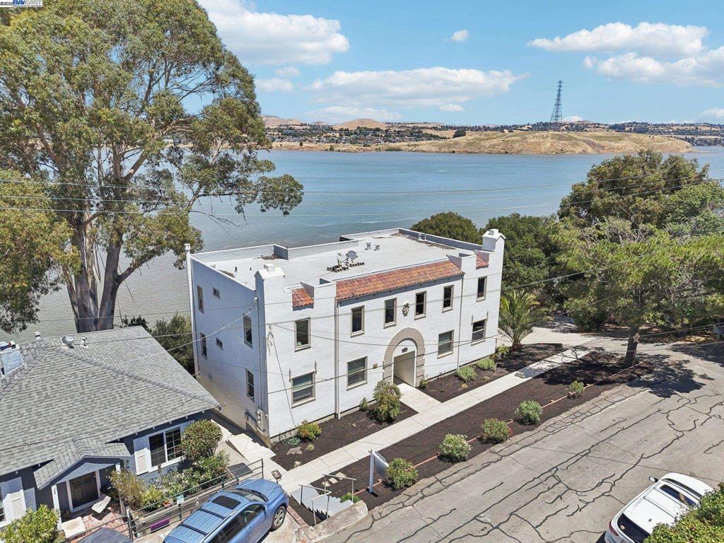 Beautifully maintained 1926 triplex overlooking the Carquinez Straits, fully renovated by contractor owners in 2010. Upgrades include new engineered foundation with drainage, driveway, plumbing, electrical, HVAC, windows, roof, kitchens, baths, carpet, and refinished hardwood floors. Top floor: 3BR/1BA with living, family, and dining rooms, balconies, patio, and sweeping views. Lower level: two 2BR/1BA units for rental income. Attached 2-car garage plus 4 spaces. Surrounded by open-space parks, trails, and a mild climate, near Cal State Maritime, dining, shops, and commuter routes.