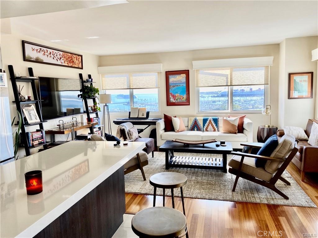 Stunning and spectacular views to be enjoyed here for all seasons, day or night. This remodeled 2 bedroom, 2 bath condo is located in the highly desireable Harbor Place Tower on the 12th floor. At just over 1,300 square feet this warm and comfortable home is newly remodeled with fresh paint, warm wood flooring throughout, a kitchen with custom cabinetry including all the modern appliances: Oven/range, refrigerator, dishwasher, and built-in Microwave. Custom lighting fixtures finish off the beautiful interior. Two balconies off the main living area and bedroom provide the perfect perspective while viewing the fabulous City of Long Beach that include panoramic views overlooking the Pacific Ocean, San Bernadino Mountains and the sparkling city lights. Bathrooms each feature walk-in showers, modern cabinetry, sinks and faucets. Two parking spaces are assigned to the unit in the gated community garage. Located blocks away from all the exciting venues in Downtown Long Beach, Harbor Place Tower is a beautiful building with a 24-hour security guard on duty, a package concierge, a pool with sun deck and spa, a large fitness center, men's and women's saunas, community room, viewing deck and 80 guest parking spaces. Pets are negotiable.