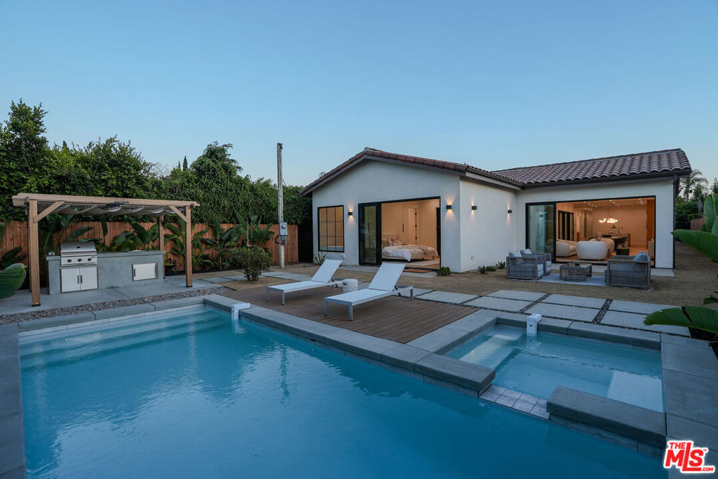 A unique One Story single-family residence in Culver City/Del Rey neighborhood sitting on a large lot, this expansive home offers a meticulously designed open living space with a great layout featuring 10ft ceiling with plenty of natural light and boasting 4 spacious bedrooms and 4 luxurious bathrooms. Upon entering the house through a custom steel door, you are greeted with 9 1/2'' wide white oak engineered wood floors and a skylight filling the entry hallway with every daylight you can get. No expense has been spared with custom white oak cabinets in the kitchen and bathrooms, Thermador built-in appliances, travertine stone finishes and European tiles along Watermark and Phylrich fixtures throughout. The thoughtfully designed layout seamlessly connects the interior to a private courtyard/Atrium and an extraordinary backyard oasis. Experience the ultimate in relaxation and entertainment with an in-ground heated pool and jacuzzi, perfect for unwinding or hosting guests. The outdoor space is a true entertainer's dream, featuring a built-in barbecue area, a cozy fire pit and an outdoor shower. Enjoy the serenity of the courtyard or soak up the sun on the spacious decks, offering ample opportunities for outdoor enjoyment. Centrally located at the end of a quiet cul-de-sac by Culver Park, the property is only a short drive from all restaurants, shopping and entertainment in Downtown Culver City, Playa vista and Mar Vista. 4936 Coolidge Ave offers functionality, warmth, elegance, and an elevated design, a MUST SEE!