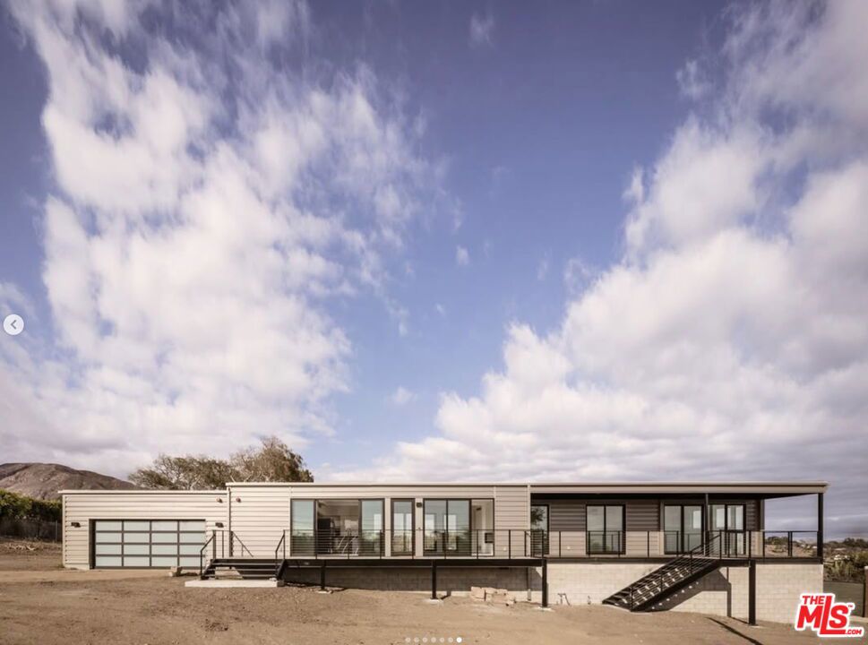 Out of the ashes, a sanctuary emerged elegant, intentional, and unshakably strong. This home is more than a residence, it's a triumph of resilience, a rebirth born from loss, and a bold architectural statement grounded in safety, serenity, and soul that was built to endure and designed to inspire. After the 2018 Woolsey Fire swept through Malibu, the land where 5782 Calpine now stands was reduced to bare earth. The owners were undeterred and viewed their land like a blank canvas filled with possibility and purpose. The owners were determined to build back better and rebuilt not just a house, but a new model for what home can mean in a wildfire-prone world. This 3-bedroom, 2-bathroom modernist retreat surrounded with equestrian trails was built with precision-engineering, fire-resistant materials and elevated with an on-site generator and was built to protect and inspire. With its soaring ceilings and steel beams, glass-framed living areas, and sweeping ocean, mountain and canyon views, 5782 Calpine is a celebration of light, space and nature. Yet beneath its minimalist beauty lies a deeply considered sanctuary, crafted to stand strong without compromising warmth or style. Strategic landscaping enhances both fire safety and aesthetics, while the thoughtful floor plan blends indoor-outdoor living from sunrise to sunset each hour of the day fills the home with natural light and serenity. Your Malibu Way of life begins here, in a sanctuary perched on 1.2 acres in the serene Malibu Park equestrian neighborhood just moments from beaches and top-rated schools. This home is more than an address, it's an invitation to begin again with intention. Resilient. Refined. Ready. 5782 Calpine is a beacon of what's possible when strength meets vision.