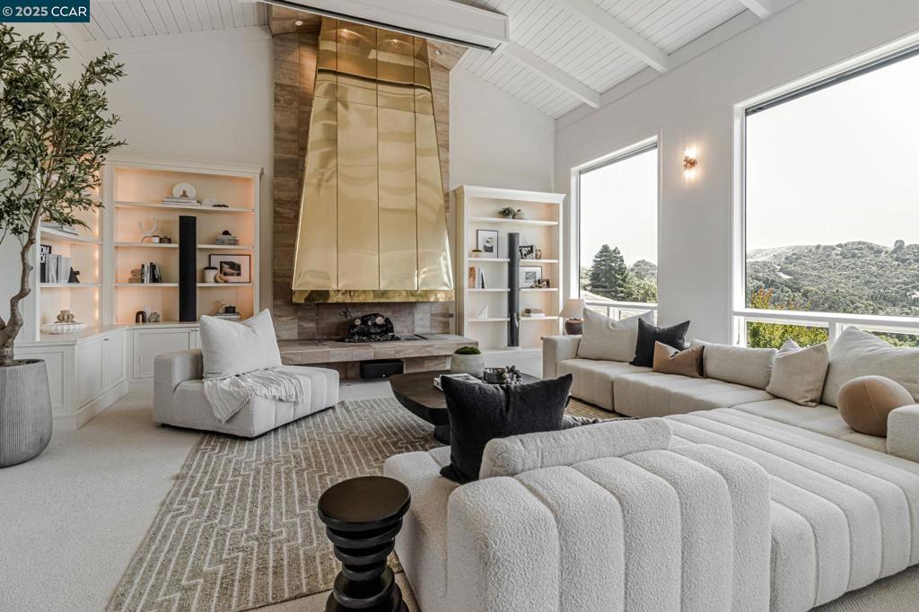 Phenomenal estate property on a private 1.61 acre lot with unparalleled views of St. Mary's College. Striking design, high ceilings, walls of windows and much more. Inviting foyer opens into the stunning great room with high-beamed ceilings, fabulous views, custom brass hood over the fireplace, built-in cabinets & shelving, AV projection system with speakers, automatic blinds and access to the deck. The primary suite also boasts amazing views, fireplace, walk-in closet and a bathroom with a double sink vanity, stall shower and a jetted tub. There is a very special generous office with two built-in desks, file cabinets, shelves and fireplace. The professionally landscaped gardens offer many different entertaining venues from playing on the front lawn, gardening, enjoying special times by the firepit in the backyard to watching the sunset from the deck. Award winning Moraga schools!
