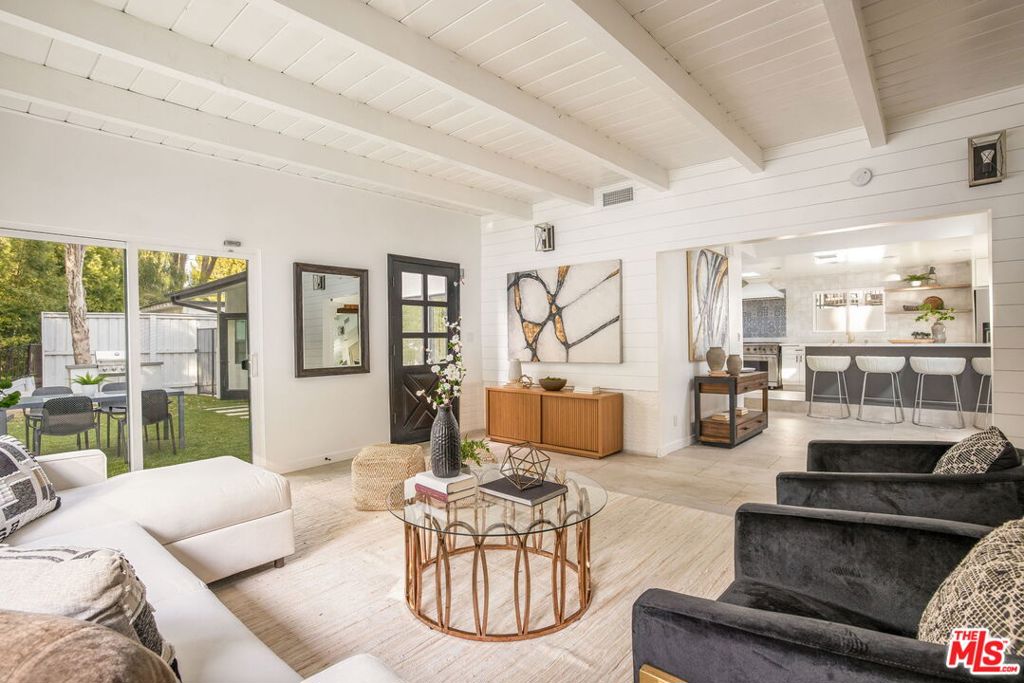 Perfectly situated south of the Boulevard in one of Encino's most desirable locations, this updated contemporary residence sits at the end of a long semi-private driveway, offering both privacy and sophistication. Step inside to discover soaring vaulted ceilings with skylights, a brick fireplace anchoring the dining room, and seamless flow into the chef's kitchen. The home features 3 spacious bedrooms, including two en-suite retreats, multiple living areas, and spa-inspired bathrooms. A versatile laundry room doubles as a potential pool house for added convenience. Recent upgrades include, HVAC, electrical, and pool systems, bringing peace of mind, all while being located in the acclaimed Lanai School District. Outside, an entertainer's paradise awaits; a sparkling pool and spa, oversized cabana, cozy fire pit, and an outdoor screening area, perfect for movie nights under the stars. Whether hosting friends or savoring quiet moments, this backyard delivers the ultimate Southern California lifestyle. All just moments from the best dining, shopping, and entertainment along vibrant Ventura Blvd.