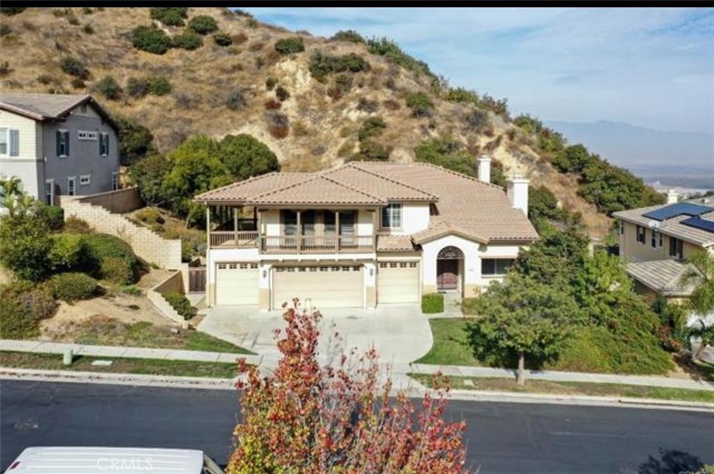 Luxurious resort-style beauty nestled in the majestic hills of Sierra Del Oro. Located on an exclusive and quiet cul-de-sac, this home rests among picturesque hillsides. A dream come true for entertainers with oversized front and rear balconies. This amazing home offers 4 bedrooms plus an office, 4 bathrooms, and one bedroom located downstairs. With 4073 sqft of living space and a 4-car garage, there's plenty of room for everyone. The beautiful living room has a high vaulted ceiling, a formal room, and a cozy family room with a fireplace. The spacious kitchen offers plenty of space, a walk-in pantry, a kitchen island, and granite countertops. The large kitchen opens to the family room, a breakfast nook area, and plenty of cabinets for storage. Downstairs also features one spacious room with a full bath and inside laundry. The upstairs den makes an ideal study or play area. The large master bedroom has neutral colors and amazing views from every angle. The master bathroom offers dual sinks, a huge walk-in closet, a shower, and a tub. There are 3 additional bedrooms upstairs with a hallway bathroom and carpet throughout. The spacious backyard is perfect for entertaining with magnificent city light views as a backdrop. Close by are great shopping, Green River golf course, schools, and nearby parks. Easy access to 91 FWY, 241 Toll Rd, 71 expressway, Metrolink station, and Foothill Pkwy.