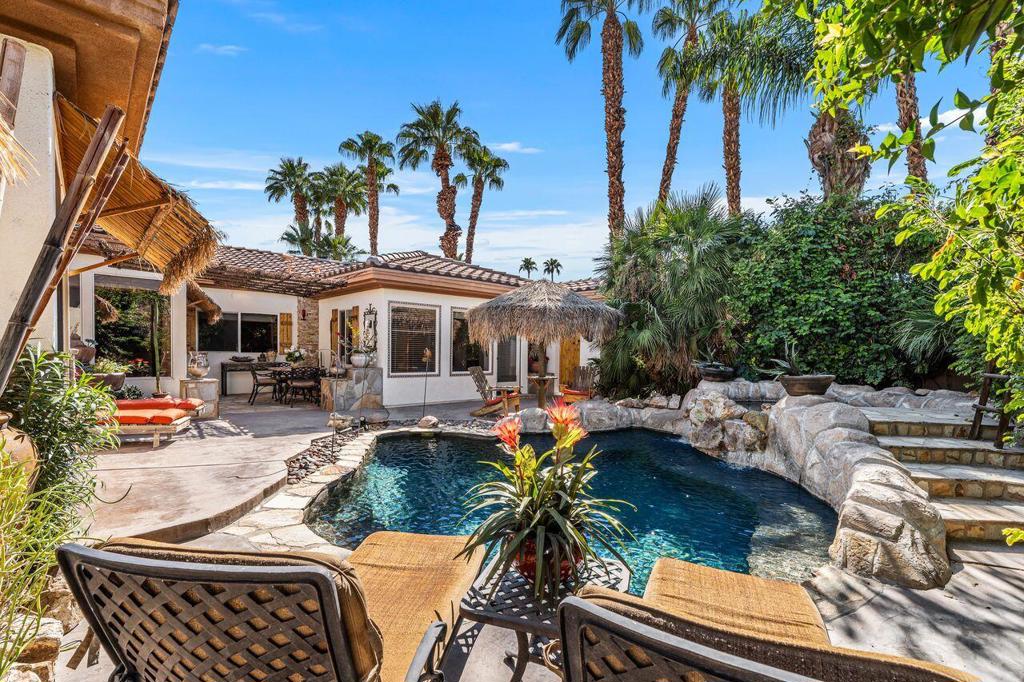 Desert living at its best! Tucked at the end of a cul-de-sac in gated Palmira, this private oasis blends style, comfort, and resort-like amenities. Featuring 5 bedrooms (one currently used as a den/office) and 3.5 baths, the home is designed around a stunning courtyard with Pebble Tec pool, raised spa, waterfall, palapa, built-in BBQ, and attached casita. The backyard extends the lifestyle with a putting green, custom rock features, and ultimate privacy. Curb appeal shines with custom pavers, desert-scape landscaping and stone accents. Inside, soaring ceilings, tile floors, and an open-concept layout connect the kitchen, breakfast nook, and family room--all with views to the pool. A cozy gas fireplace and abundant natural light create an open, airy feel. The primary suite is a serene retreat, with freestanding tub and walk-in tile shower. Offered turnkey furnished, this move-in ready home is minutes from prestigious schools, El Paseo, fine dining, golf, College of the Desert, and the McCallum Theatre. Low HOA. A rare chance to own a Palm Desert retreat that defines indoor-outdoor living! Priced to reflect the A/C unit for the main home is not working.