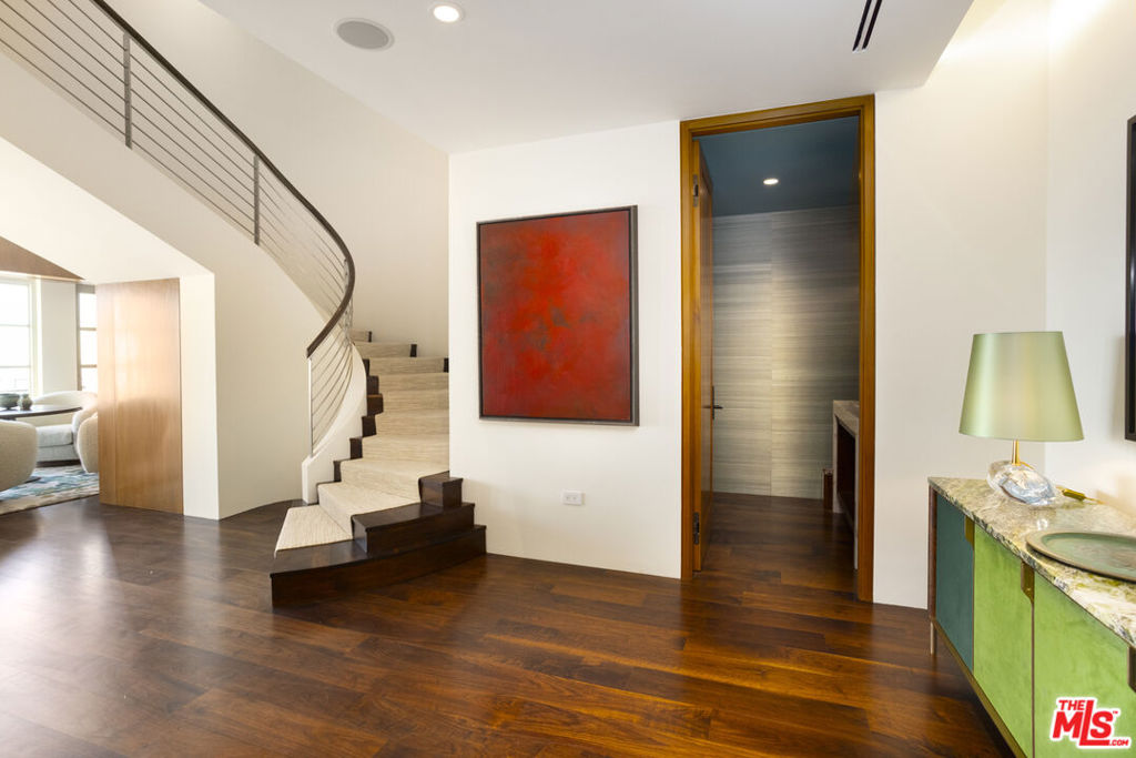 A Concierge controlled elevator whisks you up high above the bustling Boulevard to your peaceful two-story sanctuary in the sky. Comprised of the top two floors of the building, it's a true Penthouse. Greeted by its sweeping staircase, this truly feels like a home that's perched high in the clouds. There is an additional internal elevator between the first and second floor of this penthouse which makes bringing all those designer packages up to the bedrooms an effortless process. Extensively remodeled by the current owner and offered fully furnished by nationally acclaimed designer Madeline Stuart, this is the epitome of luxurious living! Beautiful custom wood panels, lustered wood cabinetry, luxurious wide plank wood floors and coffered wood ceilings bring a sense of warmth and richness to the entire Presidential Penthouse. All this while there are staggering uninterrupted views out of each and every window. There is one bedroom suite on the first floor and two bedroom suites on the second floor. There is also an additional room on the second floor that has an en-suite bathroom with shower that works perfectly as a gym/massage room or office. The den/bar area with its temperature controlled wine wall and wet bar flows into the Living Room with its beautiful ceilings and fireplace. Dining Room opens to private rooftop terrace with built in barbecue and astonishing views of the building elements that are lit at night and all of this with a backdrop of city lights. The kitchen is sleek and beautiful. Storage everywhere and lots of counter space with a fun breakfast area and a built in work area for the day help. Large laundry room outfitted completely with a separate entrance for the daily help. Then, you ascend the sweeping, sleek, steel balustrade staircase that is a work of art in itself. Two story art walls line the stairway up to the second floor. When you walk into the second floor Master Suite, the best way to describe it is like biting into a cream puff. Upon entering through the double doors to the Master Suite you feel immediately enveloped by a warm and soothing elegance with those mesmerizing views from the floor to ceiling glass walls and windows. Her bath and separate walk in closet is elegantly appointed with a dressing area and beautiful sheets of pale white stone. His bath and custom fitted closet are equally as appointed in similar stone with a large steam shower. One bedroom suite is customized as an office, befitting a CEO, with it's own jaw-dropping view, bathroom, and large walk in closet. The fourth bedroom suite can be used as an in-house gym or fourth en-suite bedroom. This is a trophy property and by far The best Penthouse in town. This prestigious property offers a wealth of amenities, including full concierge services, 24/7 valet parking, an on-site building manager, a banquet room with a fully equipped catering kitchen, a conference room, a fitness center, a pool, and secure parking for up to 3 cars. Welcome to "The Wilshire".