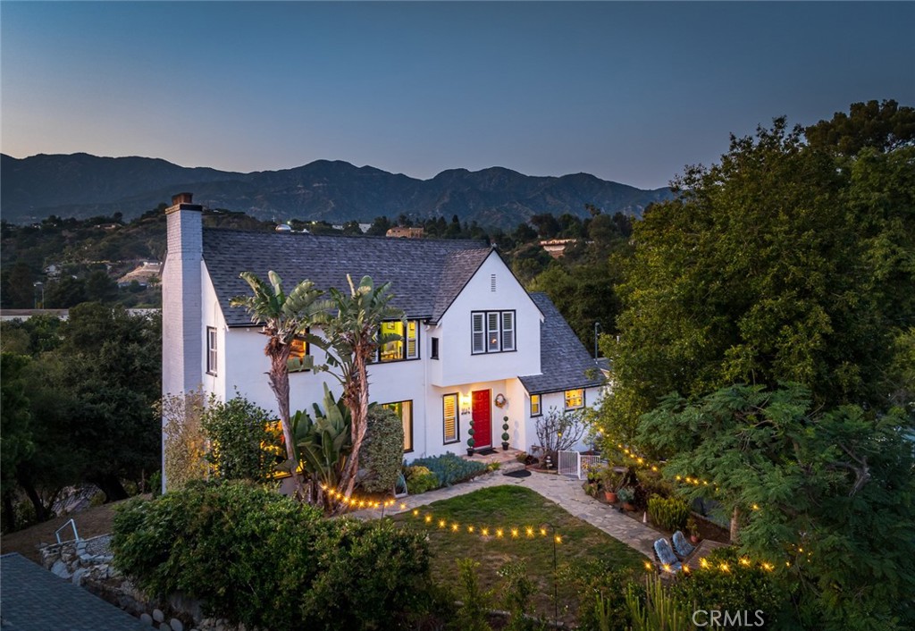 Tucked away in the award-winning La Cañada School District, this charming traditional home offers the style and ambiance of a Hollywood Hills retreat. Set on an expansive 11,000+ sq ft lot with scenic sweeping views of downtown Los Angeles and the San Gabriel mountains from nearly every room, the home features a wood-beamed living room with fireplace, formal dining room, eat-in kitchen with granite counters. With three bedrooms upstairs and a fourth downstairs, the home offers a versatile layout perfect for multi generational living, guest accommodations, or a private home office. Upgrades include a recently remodeled bathroom, 3-zone HVAC, copper plumbing, newer windows, and a 2-car garage with ample storage. A true sanctuary with street-to-street lot and just moments from top-rated schools, shops, and restaurants.