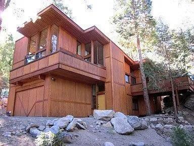 Experience the artistry of renowned architect Dennis McGuire in this exceptional mountain retreat, perfectly situated on one of Idyllwild's most coveted streets and surrounded by million-dollar homes. Step inside to discover open-concept living spaces flooded with natural light, soaring grand ceilings, and breathtaking views from every window.This thoughtfully designed home offers 2 spacious bedrooms and 2.5 bathrooms, including a luxurious primary suite. An open office loft provides the ideal setting for remote work or creative pursuits, while the inviting living area features a stunning wood-burning fireplace-perfect for cozy evenings.Enjoy seamless indoor-outdoor living with multiple decks that invite you to relax and take in the serene mountain vistas. Additional highlights include a two-car garage with laundry, ample storage, and a flexible floor plan ideal for both entertaining and everyday living.This is a rare opportunity to own a signature McGuire home in an exclusive neighborhood-where privacy, elegance, and timeless design come together.