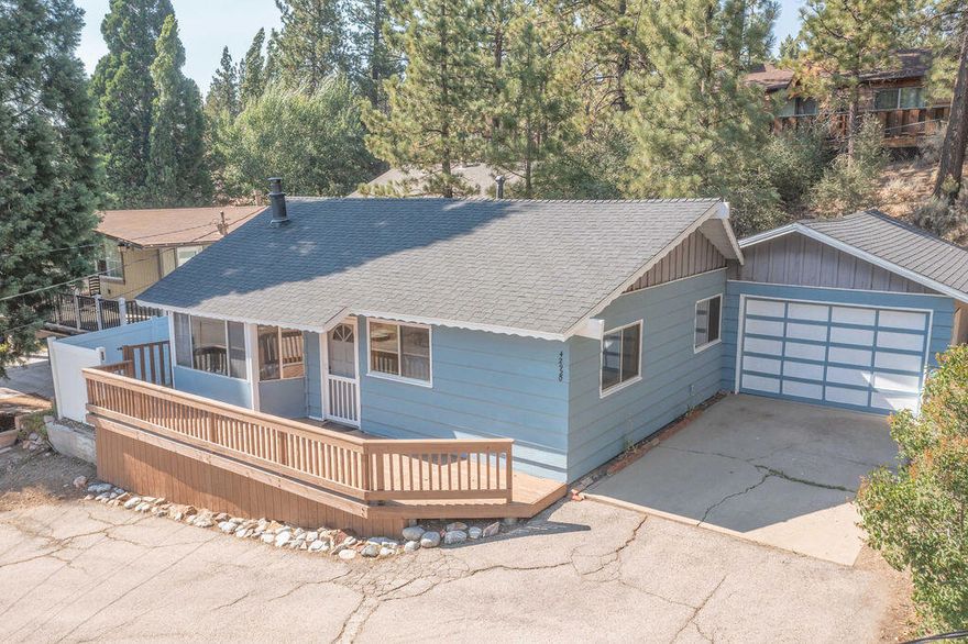 Prime Moonridge location with Ski Slope views! Conveniently located near the base of Bear Mountain Resort, the Big Bear Alpine Zoo, the golf course, and the Moonridge corridor, this home offers year-round appeal. Enjoy stunning ski slope views of both Snow Summit and Bear Mountain. Perfect as a short-term rental, second home, or full-time residence. Inside, you'll find a spacious single-level floor plan with vaulted open-beam ceilings in the living and dining areas, dual-pane windows, and an efficient wood-burning stove for cozy winter nights. The kitchen features charming knotty pine cabinetry, newer stainless-steel stove and refrigerator, built-in dishwasher, and plenty of storage. A separate laundry room adds convenience. Additional features include a two-car garage, fenced backyard with dog run, and furnishings included per seller's inventory (at no monetary value).