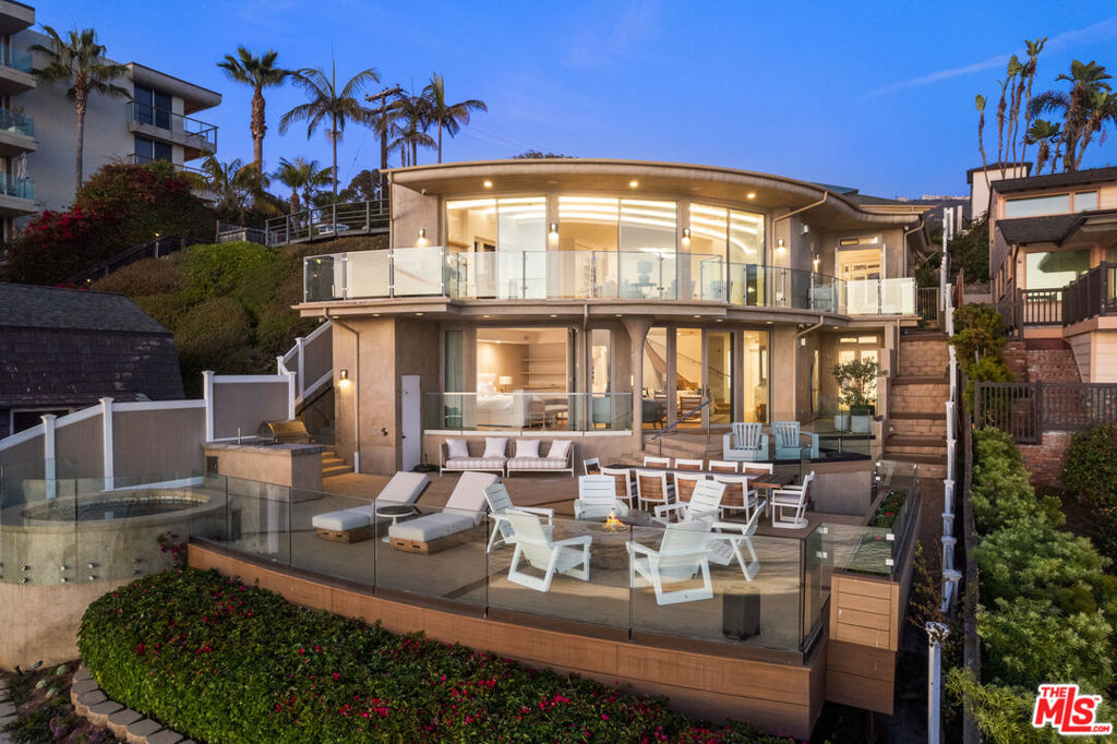 Perched above the pristine Totuava Beach with private steps leading directly to the sand, this gated estate embodies the pinnacle of coastal Orange County luxury. Situated on a rare 21,000-square-foot lot, the property features a newly remodeled main residence and a separate guest house, both designed to maximize breathtaking, unobstructed views of the Pacific Ocean, Catalina Island, and vibrant sunsets. The main residence offers 3 spacious bedrooms, an open-concept layout, and walls of glass that seamlessly blend indoor and outdoor living, allowing the striking blue waters to serve as your everyday backdrop. Designer finishes elevate every corner, creating a sophisticated yet inviting retreat. The detached guest house is equally impressive, boasting its own private entrance, a full kitchenette, one bedroom, and a beautifully appointed full bathroom. Crafted with the same attention to detail as the main residence, it offers privacy and comfort for guests or extended family. What truly sets this estate apart is the private beach bungalow nestled directly on the sand. Complete with running water and electricity, this one-of-a-kind space is perfect for unwinding after a day by the ocean or entertaining with ease. Outdoor living is a dream with a fire pit, spa, built-in barbecue area, and multiple seating areas designed for gatherings of all sizes. Ample parking is a rare treasure on Laguna Beach's coastline, but this property exceeds expectations with a 4-car garage and a massive motor court accommodating up to 6 additional vehicles. From the panoramic views to the luxurious amenities, every detail of this property has been thoughtfully curated for effortless entertaining and serene beachfront living.