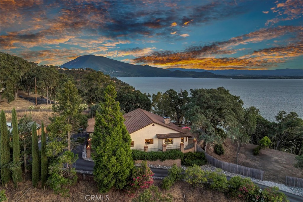 Welcome to 6949 Panoramic Dr in Lucerne – a spacious 2,390 sq ft home offering 3 bedrooms and 3 bathrooms, built with comfort and functionality in mind. Nestled on a gentle slope, this beautifully maintained property showcases sweeping views of Clear Lake and the surrounding neighborhood. Inside, enjoy a well-designed layout with generously sized rooms, perfect for both everyday living and entertaining. A Generac generator provides peace of mind, automatically kicking on during power outages to keep you secure and comfortable year-round. The oversized 3-car garage offers ample storage, workshop potential, or space for your recreational toys. One of the standout features of this property is the included extra lot, which already has water connected – ideal for a second dwelling, garden, pool, or creating your own backyard paradise. This is a unique opportunity to own a lake-view property with added space and utility – all in a quiet, established neighborhood.