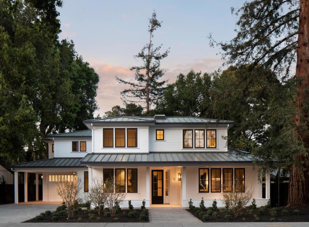 This just-completed luxury home is a stylish East Coast Farmhouse with modern panache. Spanning three levels with unrivaled space and elegance, the home is on an generous 75-foot wide lot in sought-after Professorville. The entire home is exceptionally bright and light with a palette of crisp whites, a rare finish of oak floors in a chevron pattern, and fixtures in the latest designer trend of gold and bronze hues. The result is chic and sophisticated. Ceiling heights are lofty, even on the lowermost level, and plenty of windows and glass doors invite natural light throughout all three levels, nowhere more apparent than when viewing the home from the rear and seeing full-height windows spanning every level.