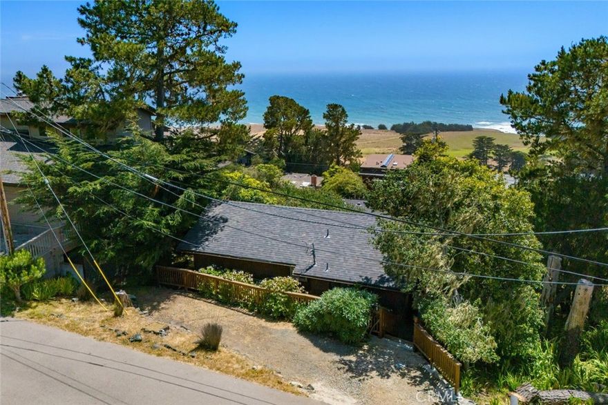 Dreaming of a rustic hideaway where ocean views and forested hills meet? Residing on one of Cambria’s most sought-after streets, this shingle-clad cottage feels like a cabin retreat with coastal beauty beyond every window! Inside, vaulted wood ceilings and a classic brick fireplace create a warm atmosphere, while wide picture windows frame sweeping vistas of sea and sky. A little care is needed to bring this gem to its full potential.

An open kitchen with ample cabinetry and an electric cooktop flows into the main gathering area, making it easy to host or unwind. Your bedroom features a charming bay window and sits adjacent to a full bath. Venture onto the large rear deck and take in spectacular panoramas of the Pacific—sunsets here are unforgettable.

With separate exterior access, the lower level offers flexible living quarters with its own bath, ideal for guests or a quiet office. Just minutes from Fiscalini Ranch Preserve and overlooking the Rancho Marino coast reserve, explore the rich heritage of this stunning seaside locale. Experience how this amazing home expresses the pure essence of Cambria!