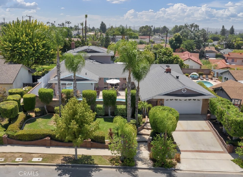 This spacious and versatile residence offering 6 bedrooms, 4 bathrooms, and 3718 sq ft of living space on an expansive 10988 sq ft lot. Perfectly designed for multi-generational living this home combines comfort, privacy, and entertainment in one of Brea’s highly desired neighborhoods. With 4 downstairs bedrooms and 2 bedrooms upstairs, a portion of the property could be used for rental income, making it an ideal setup for generating extra revenue or accommodating extended family. Additionally, there's a separate office with a private entrance, perfect for remote work. From the moment you arrive, you’ll be captivated by the beautifully landscaped front yard, with stunning brickwork and enclosed by a block wall for added privacy. The gated pool area is an ideal spot for enjoying sunny days. A two-car garage provides convenient side-door access to the covered front walkway, leading to the welcoming front double-door entry. Inside, the floor plan offers vaulted ceilings in the living room, highlighted by a cozy fireplace that sets the tone for relaxing evenings. Adjacent is a spacious formal dining area with French doors to the backyard, creating a seamless indoor-outdoor flow for entertaining. The kitchen offers a gas range, breakfast bar seating, and abundance of natural light, complemented by an additional dining area featuring a chandelier and French doors opening to the front courtyard with views of the pool. Downstairs also includes an oversized laundry room with built-in cabinetry, countertop space, and a sink for convenience. The main level hosts a full primary suite with an ensuite bathroom, as well as three additional bedrooms and a full bath. One of the standout features is the secondary unit within the home constructed in 1980, which offers excellent potential for rental income. Accessible through the main level or side gate with a separate entrance, this private space includes a living room with fireplace, kitchen, half bath downstairs, and direct access to the backyard ideal for guests, or generating rental revenue. Upstairs in this unit, you’ll find a full bathroom and two bedrooms. The backyard is equally inviting, with a covered patio, grassy play area, and a large patio space perfect for gatherings. Fruit trees, including pomegranate, avocado, lemon, fig, guava, and mango, seasonal harvests. A storage shed adds even more functionality. With generous space, pool, income potential, and a prime location, this home has it all.
