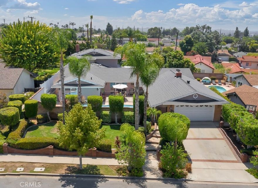 This spacious and versatile residence offering 6 bedrooms, 4 bathrooms, and 3718 sq ft of living space on an expansive 10988 sq ft lot. Perfectly designed for multi-generational living this home combines comfort, privacy, and entertainment in one of Brea’s highly desired neighborhoods. With 4 downstairs bedrooms and 2 bedrooms upstairs, a portion of the property could be used for rental income, making it an ideal setup for generating extra revenue or accommodating extended family. Additionally, there's a separate office with a private entrance, perfect for remote work. From the moment you arrive, you’ll be captivated by the beautifully landscaped front yard, with stunning brickwork and enclosed by a block wall for added privacy. The gated pool area is an ideal spot for enjoying sunny days. A two-car garage provides convenient side-door access to the covered front walkway, leading to the welcoming front double-door entry. Inside, the floor plan offers vaulted ceilings in the living room, highlighted by a cozy fireplace that sets the tone for relaxing evenings. Adjacent is a spacious formal dining area with French doors to the backyard, creating a seamless indoor-outdoor flow for entertaining. The kitchen offers a gas range, breakfast bar seating, and abundance of natural light, complemented by an additional dining area featuring a chandelier and French doors opening to the front courtyard with views of the pool. Downstairs also includes an oversized laundry room with built-in cabinetry, countertop space, and a sink for convenience. The main level hosts a full primary suite with an ensuite bathroom, as well as three additional bedrooms and a full bath. One of the standout features is the secondary unit within the home constructed in 1980, which offers excellent potential for rental income. Accessible through the main level or side gate with a separate entrance, this private space includes a living room with fireplace, kitchen, half bath downstairs, and direct access to the backyard ideal for guests, or generating rental revenue. Upstairs in this unit, you’ll find a full bathroom and two bedrooms.  The backyard is equally inviting, with a covered patio, grassy play area, and a large patio space perfect for gatherings. Fruit trees, including pomegranate, avocado, lemon, fig, guava, and mango, seasonal harvests. A storage shed adds even more functionality.  With generous space, pool, income potential, and a prime location, this home has it all.