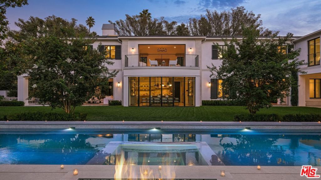 Indisputably elegant and inviting, 1000 Laurel Way is where inspired modern design meets the best of refined Beverly Hills living. Known as The Laurel House, this nine-bedroom, 14-bathroom estate has been masterfully crafted by famed West Coast-based architect William Hefner and encompasses nearly 16,000 square feet of bright, airy living areas over three levels. Set on nearly one acre, The Laurel House is a shining example of Hefner's signature style, which seamlessly blends timeless interiors with the outdoors to create breezy, host-ready spaces that are at once airy and intimate. Inside, a double-height entry presents a grand statement staircase and endless alluring design details, including hardwood floors, eye-catching light fixtures, stately columns and artfully arched windows. The open main-level floor plan features a chef's kitchen with marble-topped counters, a large eat-in island, stainless steel appliances plus a breakfast area and adjoining family room all imbued with natural light from walls of windows. Two offices with ensuites offer seamless, professional work-from-home spaces. A second catering kitchen is located behind the main kitchen, ideal for accommodating large-scale events. A gallery hall connects the kitchen to the formal dining room and living room, which is lined with glass pocket doors that disappear to reveal the expansive, park-like grounds' mature trees and privacy-enhancing foliage, a sparkling reset oversized pool with built-in seating, an outdoor kitchen, stand alone resort-style cabana, fire pits and a lush expanse of grass. Ascend to the second level to find four ensuite bedrooms with adjoining family rooms, as well as the primary suite with dual baths both with soaking tubs a private bar, fireplace, designer closets and two balconies overlooking the verdant grounds. The lower level is an entertainer's dream, replete with two ensuite bedrooms, a glam room, a 12-seat screening room, wine cellar with a tasting room and gym with an infrared sauna. Additional home amenities include a one-bedroom detached guest house and a gallery garage that can accommodate up to 10 cars. The Laurel House is where today's most discerning residents can revel in classically chic, resort-like Beverly Hills living from within a true architectural masterpiece. This one-of-a-kind home is conveniently located just 5 minutes from The Golden Triangle's shops and restaurants and the iconic attractions of West Hollywood and The Sunset Strip. Property is also available For Lease at $165,000/Mo.