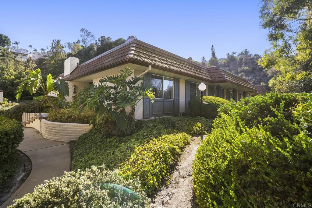 Tucked away in the desirable Talmadge community, 4622 Collwood Lane offers a rare blend of privacy and convenience. Backing to a peaceful green canyon with no neighbors or pathways behind, this single-level home provides a serene retreat just minutes from downtown San Diego. With only one shared wall, three spacious freshly painted bedrooms, and a thoughtful open layout, it balances modern comfort with a sense of calm and seclusion. Inside, the open floor plan seamlessly connects the updated kitchen, dining, and living areas—perfect for both everyday living and entertaining. The kitchen features abundant storage, while the living room is anchored by a cozy fireplace and filled with natural light from double-pane windows. Beautifully updated bathrooms and plentiful storage throughout add to the home’s appeal. A private patio creates the ideal setting for outdoor dining or relaxation, with direct access from one of the home’s two attached garages—offering both convenience and extra storage. Collwood Park is a low-density community spanning 26 acres, offering 3 large pools (one heated year-round), 2 spas, a clubhouse, walking paths, and lush landscaped grounds. It’s the perfect setting for residents who want both relaxation and recreation right outside their door. Located in a quiet hillside enclave, this property offers tranquility while still being just minutes from SDSU, major freeways, restaurants, shops, and downtown San Diego. Don’t miss the opportunity to call this charming Talmadge property your own—a private retreat in the heart of San Diego living.