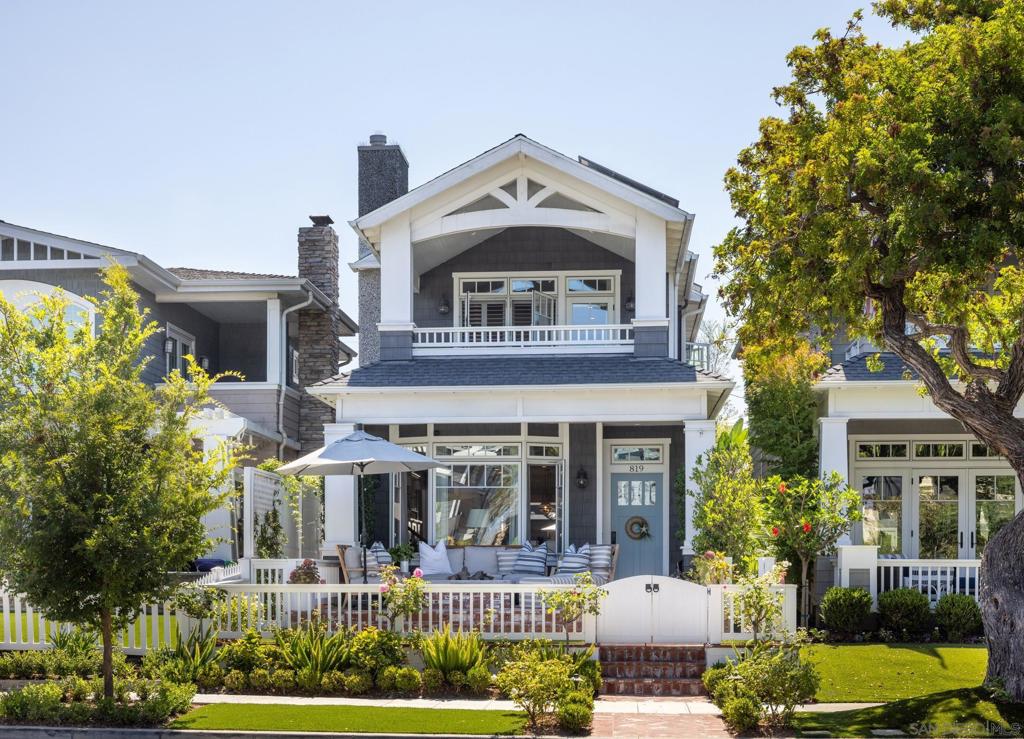 On one of Coronado’s most beloved streets, tucked behind a charming façade, is a home that feels almost perfect. From the moment you step inside, you’re struck not just by the beautiful craftsmanship—the trim work, the warm wallpapered walls, the carefully chosen finishes—but by the way the home invites you in. Here, life flows seamlessly from indoors to out. Mornings begin on the sunlit patio with coffee in hand, and evenings wind down around the glowing backyard fireplace or the front porch rock fire pit. A seven-person hot tub waits under the stars, turning even an ordinary Tuesday into an occasion. Every detail has been thoughtfully designed to feel both polished and welcoming. The vaulted ceilings in the primary suite enhance the impact, while a private balcony provides quiet moments away from it all. With 4 bedrooms and 3.5 baths, there’s space for everyone—whether family staying for the weekend or friends dropping by after the beach. A Sonos AV system fills the home with music, setting the rhythm for every gathering or quiet evening in. Elegance meets practicality with an oversized kitchen island, two laundry rooms, a 25-panel fully-owned solar system, remote-controlled window shades, a full two-car garage, and ample storage. The thoughtful layout makes living comfortable, and the overall feeling is that you’ve arrived somewhere that’s both brand-new and timeless. This isn’t just another Coronado home. It’s a place where every day feels like a holiday. Property features built-in gas barbecue, dual ceiling heaters in the outdoor covered entertaining area, outdoor shower, mature privacy hedges, a sideyard fountain, multiple Samsung Frame TVs, built-in wine cooler and upgraded finishes in every room.