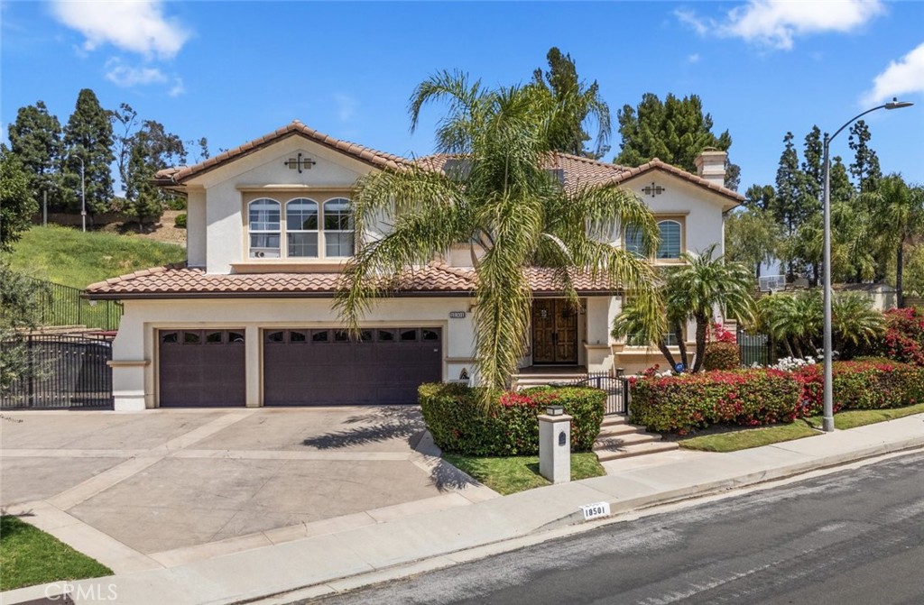 Tucked away in one of Porter Ranch’s most sought-after communities, this exceptional 4,602 sq ft residence offers a level of privacy and luxury that’s nearly impossible to find. Entered inside and you’re immediately welcomed by an open, light-filled floor plan designed for both elevated everyday living and unforgettable entertaining. With 4 spacious bedrooms and 5 bathrooms, every corner of this home has been thoughtfully curated for comfort, flow, and style. At the heart of the home is a stunning chef’s kitchen—featuring a massive center island perfect for morning coffee or evening cocktails, custom cabinetry, sleek quartz countertops, and top-of-the-line stainless steel appliances. The kitchen opens effortlessly to a generous family room complete with a built-in bar, media center, and sliding doors that invite the outdoors in. Upstairs, your primary suite is a true escape. Wake up to serene views and end your day on the private balcony with a glass of wine. The spa-inspired bathroom features a soaking tub, oversized walk-in shower, and dual vanities—every detail designed to help you unwind. Outside, the backyard is your personal resort. Whether you're hosting a summer soirée or enjoying a quiet weekend at home, you’ll love the sparkling pool, outdoor kitchen with built-in BBQ, multiple lounge areas, and a private half basketball court. This space was made for gathering, relaxing, and living life to the fullest. Additional highlights include a 3-car garage, RV access, high ceilings, abundant natural light throughout, three en-suite secondary bedrooms, custom built-ins, and owned solar panels. Minutes from The Vineyards at Porter Ranch, top-rated schools like Granada Hills Charter and Frost Middle, scenic parks, and upscale dining—this is a one-of-a-kind opportunity to enjoy luxury and privacy in one of the Valley’s most coveted neighborhoods.