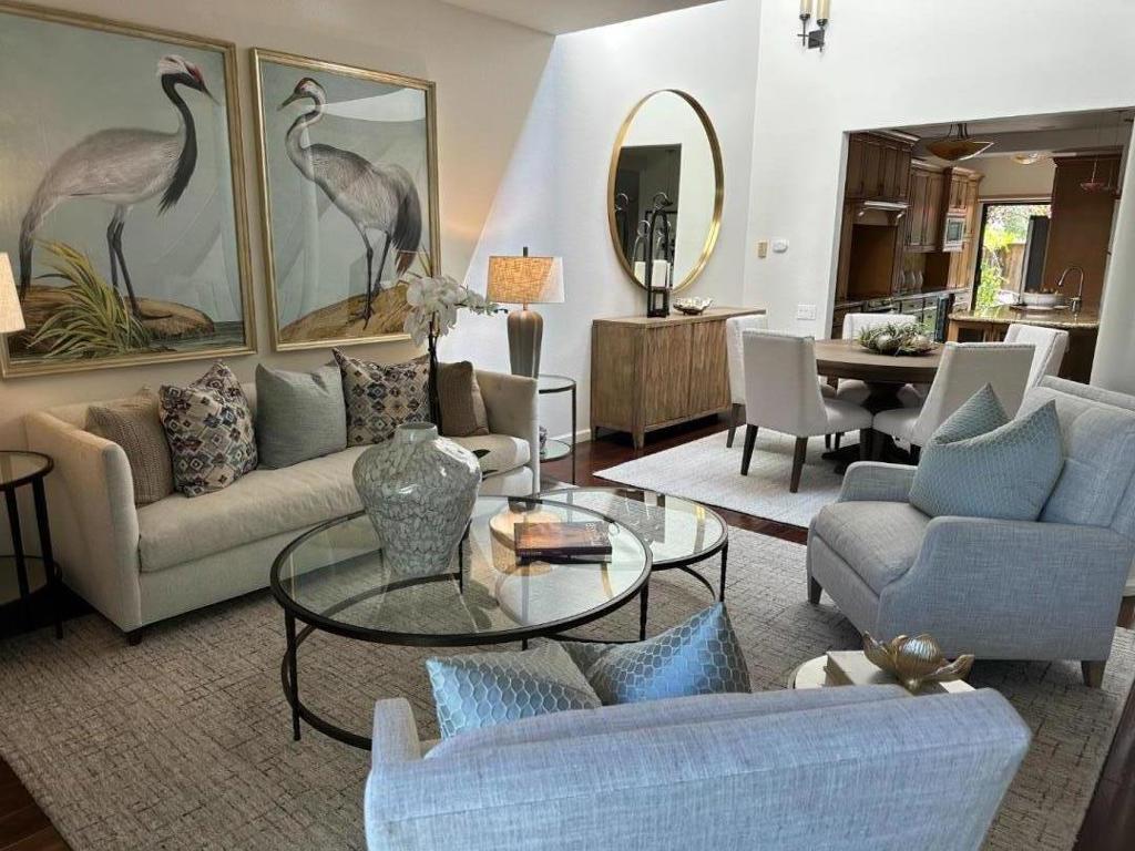 NO SHOW UNTIL AFTER SATURDAY OPEN HOUSE Elegant Waterfront Townhouse - A Masterpiece of Design and Detail Step into a world of architectural artistry in this exceptional home, where no expense has been spared and every detail has been carefully curated. The exquisitely redesigned kitchen blends function with luxury. A skylit dining area is enhanced with elegant sconces, while the living room centers around an abundant wall space for your art collection and a wood-burning fireplace, which opens to a waterfront patio. Wood flooring flows throughout most of the home.The same ambiance continues upstairs. The open loft area offer a versatile canvas for your lifestyle. The second bedroom charms with angled lines, and the hall bath echoes the home's refined aesthetic. The primary suite is a vaulted sanctuary with water views, a custom mirrored barn door, a spa-like en-suite with a grand, porcelain-tiled shower, Hansgrohe Raindance fixtures, marble-countered cabinetry, and crystal waterfall lighting. A generous walk-in closet completes the retreat.3 pools, spa, sauna, 3 pickleball & 1 tennis court. Boat docks for your kayak & paddleboard. Convenient to freeways, shopping & dining. Co-listed with Ann Ellison.