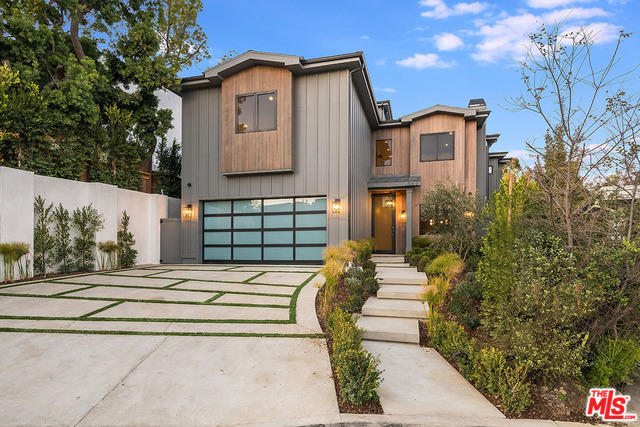 Newly Constructed Modern Farmhouse in prime Brentwood. Just completed by IM Home, with almost 7,000 sq ft, this warm & sophisticated home offers 6 bedrooms & 8 bathrooms spread over 3 levels, plus a fantastic rooftop deck with ocean views. An elevator connects all levels, providing an ideal layout, with the formal entertaining spaces, a gourmet kitchen & 1 en-suite bedroom on the main level, while 4 en-suite bedrooms occupy the upper floor. The master suite is a lavish retreat with a sitting area, fireplace, balcony, & master bath offering soaking tub, dual sinks, & steam shower. The lower level is perfect for gatherings, with a screening room, exercise room, powder room, entertainment room & the 6th en-suite bedroom. In a lush canyon setting, the backyard is like a private resort with an infinity-edge pool, spa, built-in BBQ, & waterfall. With luxury finishes & modern amenities, in a coveted location near Brentwood Village, this new home is Southern California living at its best.