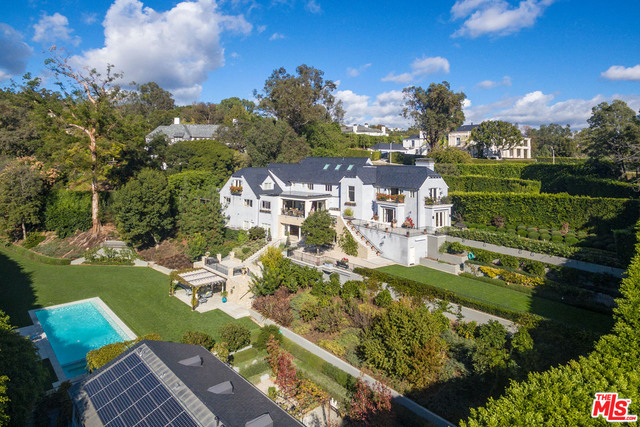 With over a thousand feet of prime frontage on one of the finest streets in the City of Beverly Hills, behind iron gates and completely private from view is a completely remodeled "Old Hollywood" traditional estate with state of the art amenities. The estate is comprised of 2 stand alone homes, a main house of approx. 11,311 sf and a 3,980 sf guest house with separate entrance creating the ultimate estate compound. The main house features large public rooms, including a beautiful living room, media room, formal dining room, a professional gourmet kitchen that opens to family room and heated loggia, beautiful master bedroom including his and hers with master closets plus 4 additional gracious family bedrooms suites upstairs. The lower level contains a temperature controlled wine room that flows out to a resort sized pool, cabana, and enormous polo field sized lawn. Completely private with manicured gardens, and a beautiful guest house complete this incredible value and package.