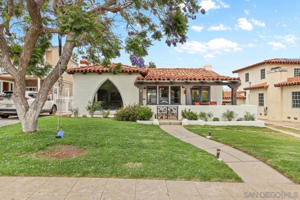 This charming 3 bedroom, 2 bath Spanish-style home is full of character and thoughtful updates. Single-level living with classic details like coved ceilings, hardwood floors, and a cozy fireplace in the living room create a warm, timeless vibe. The gourmet-style kitchen opens to an eat-in area that could easily double as a home office. Both bathrooms have been remodeled in a stylish vintage-meets-modern Spanish design, and the home has gone through the Quieter Home Program, giving it newer windows, French doors and added insulation. Out front, Saltillo tile and a covered porch sets the tone for the charm you'll find once inside, while the back deck with turf yard is perfect for easy outdoor entertaining – you even get some downtown skyline views from the deck. The low-maintenance landscaping means more time relaxing and less time doing yard work. Bonus points for paid solar (21 panels), air conditioning, an EV charger and a detached two-car garage. Super easy walkability to local schools in a friendly, established neighborhood just a few blocks from Liberty Station. This home is the perfect mix of charm, upgrades, and location.