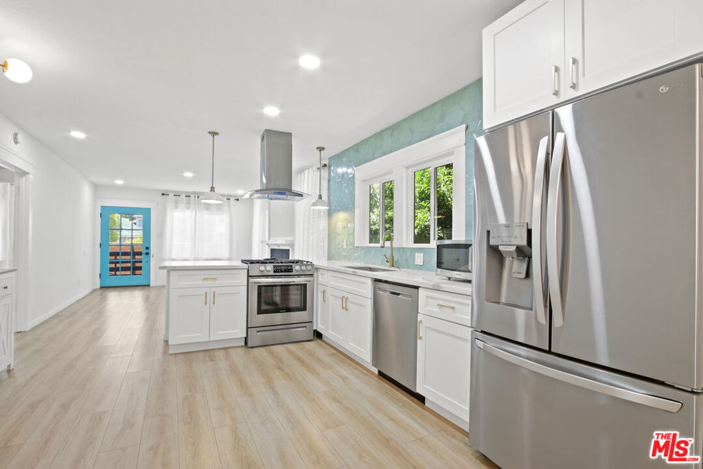 Welcome home to this beautifully renovated California Bungalow, blending modern upgrades with classic charm. This 2-bedroom, 1-bathroom home features an open floor plan filled with natural light, & energy-efficient double-pane windows. Enjoy a fully renovated kitchen with new stainless steel appliances, including a refrigerator, stove/range, dishwasher, washer & dryer, and a compact microwave. The home also offers central heating and air conditioning for year-round comfort.A detached garage provides flexible space perfect for a home office, gym, or creative studio. For added privacy and security, the property includes three gated parking spaces behind a tall motorized fence, as well as a Ring security camera system. The spacious outdoor area is ideal for entertaining, gatherings, or simply relaxing. Located just steps from restaurants, grocery stores, shops, hospitals, nightlife, and public transportation.Don't miss this opportunity to live in a stylish, move-in-ready home in a convenient and vibrant neighborhood!