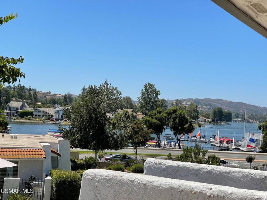 Location! Location! Exceptional Summershore condo located directly across the street from the lake! Enjoy spectacular views from the large balcony. The Landing, Yacht Club, restaurants and village shopping are across the street. This 2 bedroom, 2 bath condo has an open floor concept with hardwood floors. The living room and dining room seamlessly integrate to the large balcony (ideal for an outdoor living space). There is a lovely kitchen, fireplace in the living room, full-size washer & dryer, two car garage. The development has a community pool & spa and guest parking.  Don't miss this opportunity to live in a serene setting with walking trails, mountain and lake views.