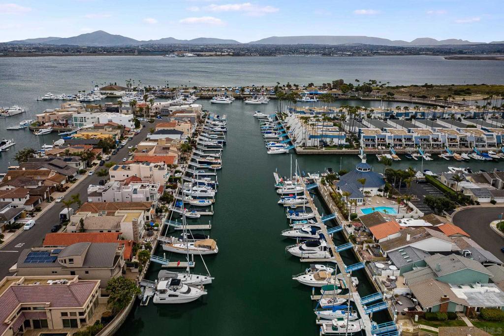 Immaculate Coronado single family residence with assigned dock located in the prestigious Coronado Cays. Situated on a quiet street adjacent to the bay. This spacious 4 bedroom, 3 bath home leaves little to be desired! Enter through custom double leaded glass front doors to open living room and large separate dining area. Custom kitchen with stainless steel appliances , Corian counter tops , breakfast bar adjacent to the family room. Main level bedroom with full bath. Outside enjoy the cool ocean breezes in your private landscaped backyard complete with jacuzzi and wrap around redwood deck. Take a walk around the block to the beach or walk across the street to your own dock and relax on the bay ! Cedar closets in oversized Master bedroom & 2 additional bedrooms upstairs Equipment: Garage Door Opener,Pool/Spa/Equipment Sewer: Public Sewer Topography: LL