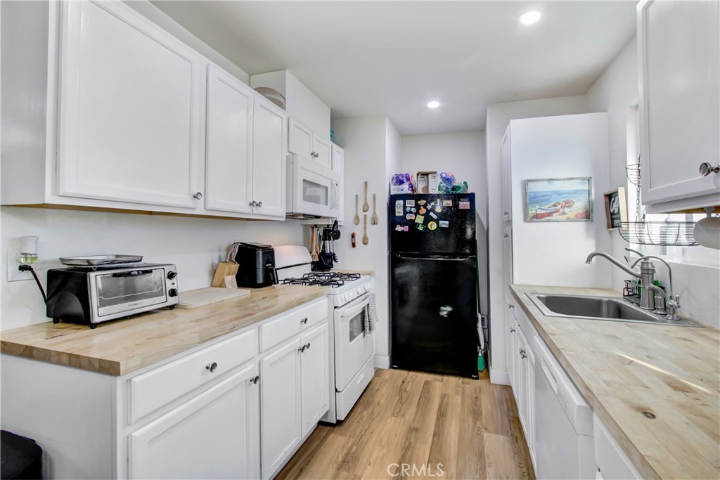 Assumable 5.9% Loan at $400,000. Ask about the $15,000 buyer assistance program (forgivable loan) that can be used for closing costs, rate buy-down, or down payment. No interest, no payments, and it’s forgiven over 5 years! *Also available FHA with 10K in closing costs. Located just 8-minutes from the Lake Elsinore Launch Pointe Recreation Destination, step inside this charming light and bright 2-bedroom, 1-bathroom home in Lake Elsinore, where comfort meets functionality. The spacious living room offers plenty of room to relax and flows seamlessly into a bright galley kitchen filled with natural light with fresh butcher block countertops. Recessed lighting throughout the home adds a modern touch. The full bathroom is finished with crisp white cabinetry and a marble sink. The roomy primary bedroom features a double-pane sliding door that opens to a covered patio—perfect for enjoying your morning coffee or winding down in the evening. Outside, the backyard offers great potential to create your own private oasis. Whether you're dreaming of a garden, play area, or entertaining space, there's room to make it happen. Broker and agents do not represent or guarantee the accuracy of the square footage, income, expenses, condition, development potential, bedroom/ bathroom count, lot size or lot lines, dimensions, permitted or non-permitted spaces, or school eligibility. Buyer is advised to independently verify the accuracy of all information with appropriate professionals. There are no warranties or guarantees, buyer to rely solely on his/her/their own findings.