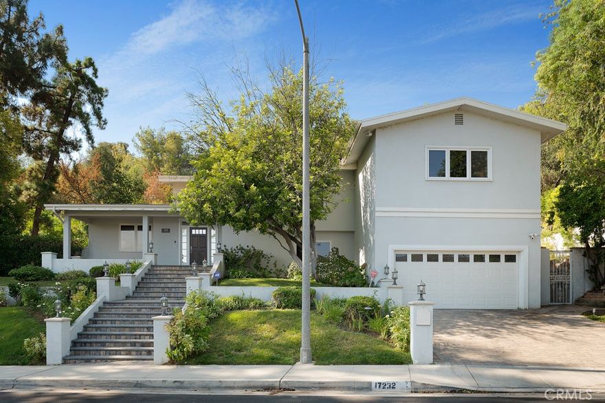Welcome to this exquisite and charming residence situated in the prestigious Encino hills. This beautiful traditional home has been thoughtfully remodeled, showcasing meticulous attention to detail throughout. Upon entering, you'll be greeted by the timeless elegance of hardwood flooring. The kitchen has been tastefully upgraded with high-end, state-of-the-art appliances, exuding brightness and a welcoming ambiance. Granite countertops complement the elegant white washed cabinetry, creating a harmonious and sophisticated atmosphere. The bathrooms boast luxurious Walker Zanger tiles, adding a touch of opulence to the space. Natural light floods the interior through skylights, providing a warm and inviting feel to every room. The center hall floor plan offers ample space, featuring four bedrooms and three and a half bathrooms, ensuring comfort and privacy for all residents. The large yard is a private sanctuary, complete with a stacked stone pool and spa, perfect for relaxing and entertaining. Embrace the tranquility and timeless allure of this remarkable home in the heart of Encino hills, where traditional charm meets modern sophistication.