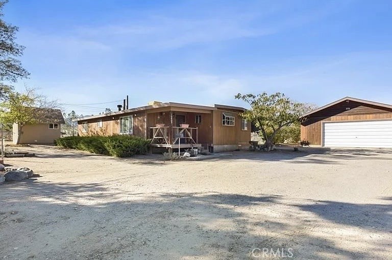 Discover Peaceful Living at Its Best in Phelan, CA! Are you dreaming of space, serenity, and a place where you can truly connect with nature? Look no further—this incredible property offers it all and more! Nestled on a fully fenced 2.5-acre lot, this charming country retreat is a rare gem that combines comfort, functionality, and endless possibilities! Step into a beautifully spacious home featuring 4 generously sized bedrooms, 2 full bathrooms, a versatile office space, and a large living area perfect for cozy nights or lively gatherings. You'll love the detached, oversized laundry room, as well as the welcoming front and back porches—ideal spots for sipping coffee at sunrise or watching breathtaking desert sunsets.
The backyard is an entertainer’s paradise, complete with a large patio area perfect for BBQs, celebrations, or simply enjoying the peace and quiet under the stars. But wait—there’s more outside than you can imagine! This property is packed with bonus features, including: a detached 2-car garage, a massive and covered parking/workshop area, a greenhouse, a fenced garden, and a chicken coop. On top of that, multiple storage sheds, one of them it's even equipped with a kitchen! TWO large outdoor showers left by the seller for your convenience. ALSO, this property has different water connections throughout the lot for you do a lot more with this property.
Located in a prime area of Phelan, you're just minutes from schools, shopping, and daily conveniences—yet far enough to enjoy the quiet, open skies and mountain views this desert escape offers. Whether you're looking to homestead, entertain, garden, or simply stretch out and breathe, this property is brimming with potential to become your dream home. Don't miss this one-of-a-kind opportunity—schedule your private showing today and fall in love with the lifestyle you've been waiting for!