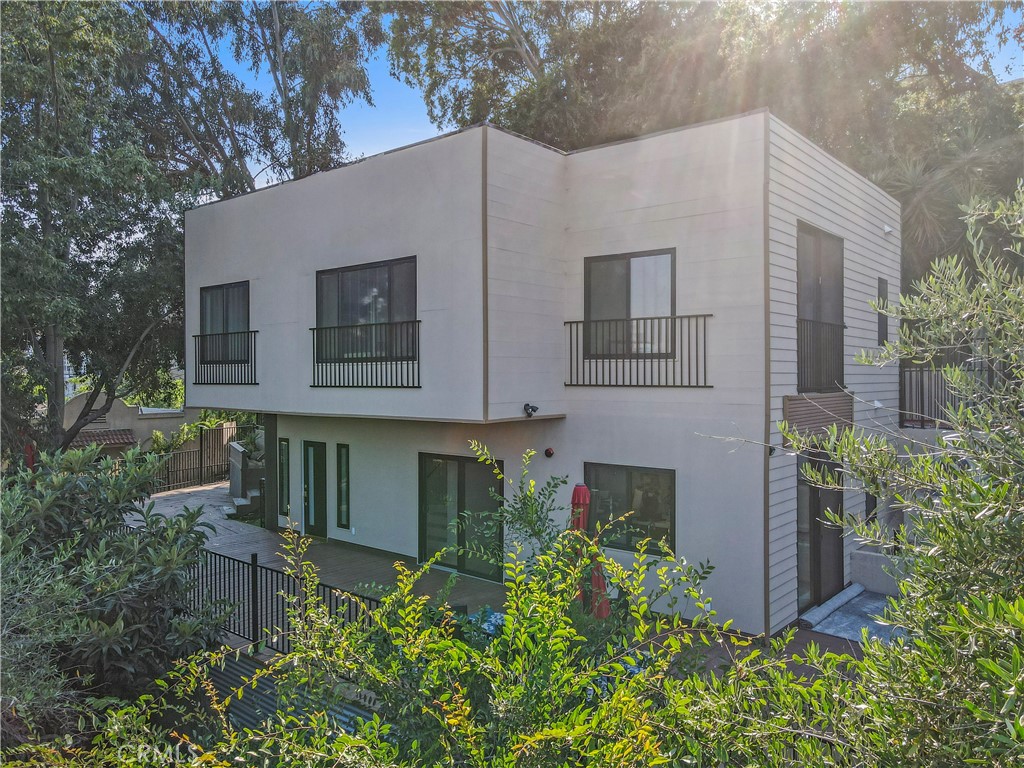 Own a piece of Silver Lake history on the iconic Loma Vista stair street. Perched high above the city with panoramic views, this 2024-built hillside home blends privacy, modern comfort, and artistic charm. The property includes 3 bedrooms and 3 bathrooms across a flexible layout that functions as a full two-story residence or can be separated into a 2 bed / 2 bath main home and a 1 bed / 1 bath guest unit - ideal for rental income, an in-law suite, or a private office. The main home features an open-concept design with a striking Calacatta Gold Quartz kitchen island, designer finishes, and Andersen sliding glass doors that open to a spacious wraparound deck - perfect for relaxing, entertaining, or enjoying quiet moments among the treetops. Upstairs offers a bonus den, two sunlit bedrooms, and a luxurious bath with porcelain tile and gold accents. The private studio ADU includes its own entrance, full bath, garden, and balcony - ideal for guests, a home office, or supplemental income. Additional highlights include a gated entry, private shared driveway, and recorded rights to install a future staircase or hill lift for easier access. Enjoy the best of Silver Lake - contemporary design, flexible living, and unmatched views on one of the area's most iconic stair streets.
