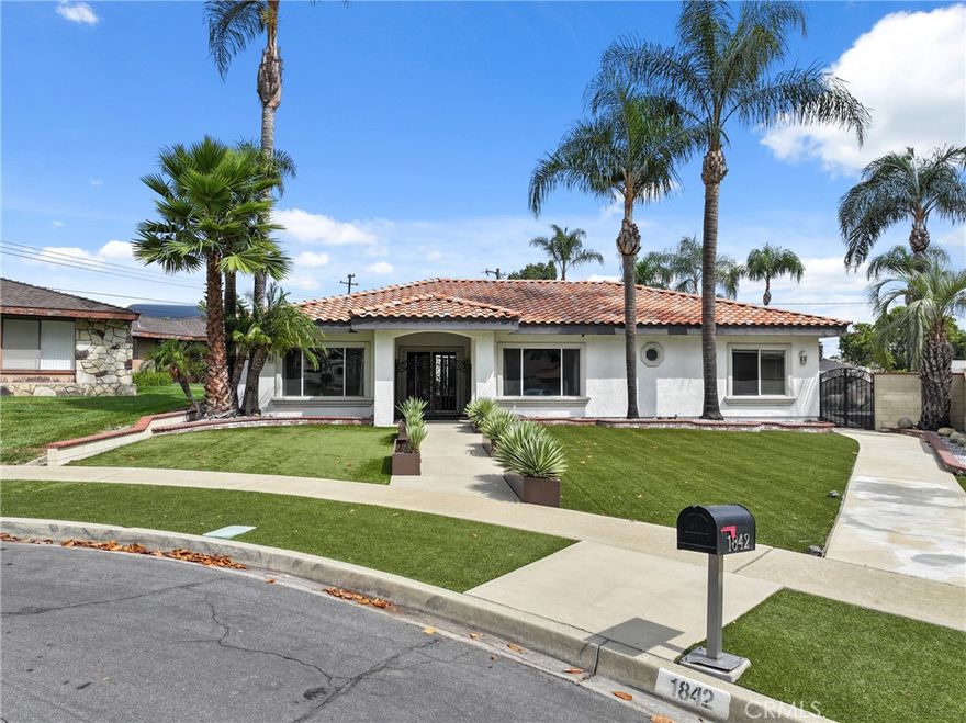 Custom beauty designed with you in mind. This very unique single story pool home is located at the end of a quiet cul-de-sac in desirable North Upland. Great curb appeal with approx. 2,800 sqft of spacious living space on 13,800 sqft lot, 5 bedrooms (1 bedroom has their own remodeled bath with outside door leading to pool area) for a total of 3.5 bathrooms. Features: custom gated front courtyard entry that leads to beautiful custom glass double door with a retractable screen door, lovely foyer welcomes you inside, bright & airy floor plan with interior courtyard atrium patio area, high 10’ ceilings with some custom tray ceilings, bull nose corners, upgraded carpeting, ceramic tile & Bamboo flooring, recessed lighting, some window shades, ceiling fans, French doors, tank-less water heater, some mirror closet doors with organizers, cost saving solar panels, laundry room for added convenience with a sink & some cabinetry. Elegant formal living room. Kitchen boasts Granite counter tops, white cabinetry, some stainless steel appliances, breakfast bar & nook area that has built-in nook bench. Family room is great for entertaining with a custom stainless steel design fireplace. Formal dining room off the kitchen with French door leading to the tropical oasis backyard and door leading to the interior atrium courtyard patio. Spacious primary suite plus beautiful primary bath boasts dual sinks, soaking bath tub, separate shower & walk-in closet with organizers. Attached 3 car garage with built-in work bench & cabinetry. Good size driveway provides room for your RV, boat &/or toys you may desire plus alley access. Professional landscaping highlighted with the great curb appeal, artificial grass/tuff, palm trees & drought tolerant landscaping. Tropical paradise backyard features Tiki BBQ island, Pebble Tec sparkling pool & spa. Beautiful custom rocks with waterfall, 10’ water slide and beach/Baja style entry into the swimming pool. Plenty of cement patio area with a fire pit to enjoy on any occasion. Fantastic views of the mountains. Desirable Upland unified school district with Peppertree Elementary, Pioneer Jr. High & Upland High school. This property is conveniently located within minutes to the Colonies Crossroad center which offers shopping, grocery stores, restaurants & more! Plus commuter friendly with 210 freeway near-by and the Metro Link station in the downtown Upland Village. Sunrun leased solar as added bonus with low electric utilities plus much more!