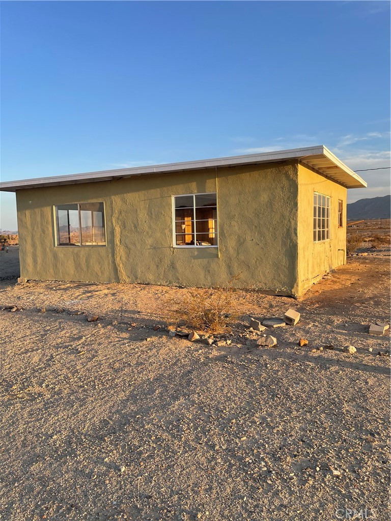 Wonder Valley 1 BR. House/Cabin with wood paneled bedroom, bathroom area and 2 large rooms, on 5 Acres!
900+/- Sq. Ft. House has 360 degree Mountain View’s , 2 fenced areas, 1 for house and one for an included 1950’s Aluminum Trailer w/ original wood interior, great for a Vacation Retreat!
Power is on and rehab has begun with a New Roof, which was torn off and replaced with new plywood and rafters!
Inside walls and ceilings have been recently
repainted!
Large 2500 gallon water tank is plumbed to house, ready for the new owner to make it their own!
Live, Vacation or rent, a great investment for the future !
Hurry, this won’t last!
Zoned as a recreational cabin.
