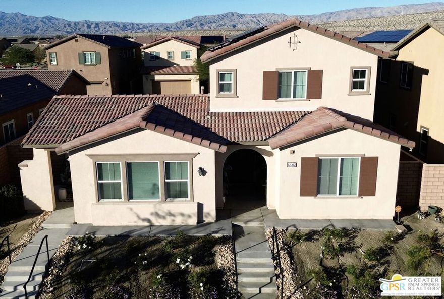 Discover this stunning 6-bedroom, 4-bathroom smart home offering 3,105 sq. ft. of beautifully designed living space. Nestled in a desirable community with gorgeous mountain views, this two-story residence features a spacious floor plan, solar power, and modern finishes throughout. The heart of the home opens to a custom pool/spa, outdoor fireplace, and built-in barbecue with a refrigerator perfect for entertaining. A private attached casita with its own entrance offers a  separate bedroom, bathroom, and living room provides ideal guest accommodations. Additional highlights include a furnished interior, 2-car garage, and proximity to shopping, dining, and freeway access. Community amenities abound with pickleball courts, pool/spa, fitness gym, and park. This is truly a must-see home combining luxury, convenience, and resort-style living!