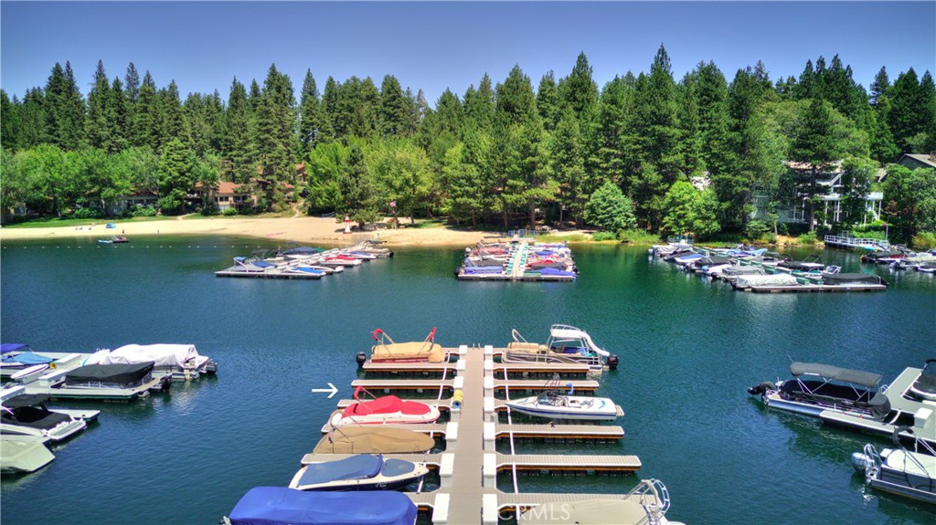 Your Own Brand-New Dock Slip in Meadow Bay – Lake Arrowhead. Here’s your rare opportunity to own a completely NEW, not rebuilt, dock slip in the highly sought-after calm waters of Meadow Bay—one of Lake Arrowhead’s most protected and desirable dock locations. Positioned toward the end of the multiple for easier access, this slip offers deep water, exceptional shelter, and incredible convenience—just a short stroll to nearby restrooms. The dock is gated for added privacy and security, and includes access to a picnic area exclusively to this multiple. Crafted by Kiwi Docks, this dock was custom-designed from the ground up to exceed modern standards of stability, safety, and style. The exterior frame is constructed of architectural-grade Alaskan Yellow Cedar, pressure-treated for durability and sealed with a rich oil-based stain. It is beautiful! The structure is reinforced with heavy-duty steel angle brackets and through-bolted hardware for lasting performance. Underfoot, you’ll find Premium WearDeck composite decking with heat-reflective technology, providing a cooler, more comfortable surface that stays strong through sun and seasons. The dock includes galvanized steel cleats, white foam-filled firehose-style dock bumpers, and a brand-new dock box for your storage needs. With a 20-year structural warranty in place, this is dock ownership at its finest—ready for seasons of low-maintenance enjoyment. You can take advantage of everything Lake Arrowhead has to offer: Boating, fishing, watersports, and a short boat ride to the Village for dining, shopping, and summer concerts. Don't miss out—this turnkey slip is priced to sell this season. Start living your lake lifestyle today!