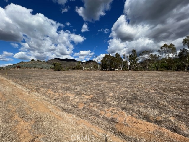 PRIME CORNER LOT WITH TWO PARCELS – Exceptional Location and Endless Possibilities! Nestled in a sought-after area surrounded by luxurious homes and thriving orchards, these two flat corner lots offer incredible potential for your dream home or investment project. The property boasts level terrain with street frontage on two sides, providing unmatched accessibility and flexibility. Gentle topography nice views down the canyon. With two water meters already on each parcels, building or cultivating is made even easier. Whether you envision a residential oasis or an agricultural endeavor, the possibilities are infinite. Easy access to Hwy 15 approximately 4 miles to intersection of Hwy 15 and Hwy 76, about 5 miles to the Pala Casino Spa Resort. Call Today!