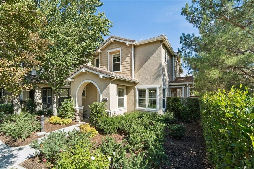 Beautifully updated Valencia home in a peaceful, tucked-away location! Rich hardwood flooring flows throughout the main level into the open kitchen featuring white cabinets, striking black quartz countertops, stainless steel appliances, and updated lighting. The spacious living and dining areas open seamlessly to a private patio yard — ideal for morning coffee or evening gatherings. Plantation shutters and designer touches add warmth and style throughout. Upstairs, all three bedrooms provide comfort and privacy, including a generous primary suite. Enjoy the Valencia Creekside community with low HOA dues, miles of scenic paseos, a clubhouse, and pool/spa amenities. Just minutes from shopping, dining, parks, and freeway access, this turnkey home blends modern upgrades with everyday convenience. No mello roos tax!