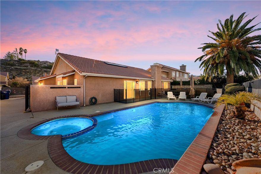**WEST SIDE POOL HOME WITH PAID-OFF SOLAR, RV PARKING W/ A View **

Welcome to a truly one-of-a-kind residence in a highly desirable west-side neighborhood, offering pride of ownership, scenic surroundings, and exceptional convenience. This remarkable pool home features no HOA, no Mello-Roos, paid-off solar, dedicated RV parking, and a fireplace in the dining area, combining style, comfort, and functionality.

From the moment you arrive, you'll be drawn in by the family-friendly community, nearby parks, excellent schools, and easy access to freeways, shopping, dining, and entertainment—including local theaters and outdoor venues perfect for concerts and movie nights.

A grand double-door entry welcomes you into an elegant formal sitting room and a warm, inviting formal dining area with fireplace, perfect for both everyday meals and entertaining. The upgraded kitchen showcases refined cabinetry and quartz countertops, flowing seamlessly into the main living spaces.

This home offers four generously sized bedrooms and an updated guest bathroom. The primary master suite is privately separated, providing a true retreat with direct backyard access. The primary bathroom is exceptionally appointed with a gorgeous vanity with custom cabinetry, dual sinks, a luxurious soaking tub, and a beautifully updated walk-in shower, offering both comfort and elegance.

Additional highlights include plantation shutters throughout, gorgeous hardwood flooring, and thoughtful upgrades throughout the home.

Step outside to your private backyard oasis, where a sparkling pool and serene views create the perfect setting for entertaining, relaxation, and enjoying Southern California living year-round.

With paid-off solar, RV parking, a dining-area fireplace, and an unbeatable west-side location, this home delivers a lifestyle that is timeless, private, and refined. Opportunities like this are rare—this home will not last.