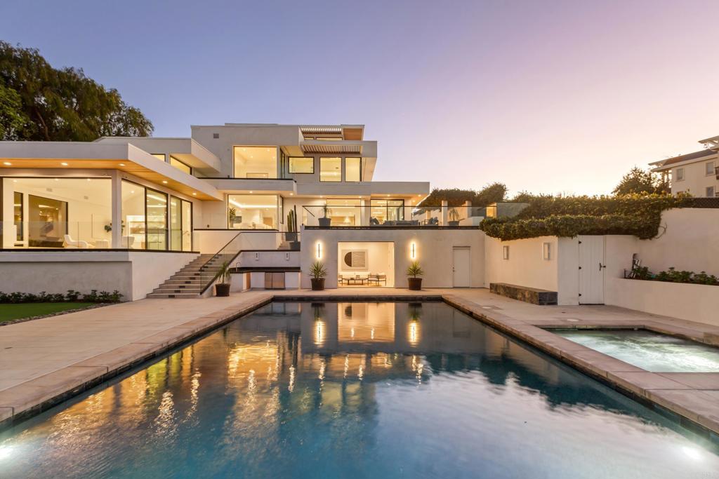 Perched in the prestigious hills of La Jolla, California, 2082 Via Casa Alta is a modern masterpiece that seamlessly blends contemporary design with unparalleled luxury. Rebuilt from the ground up, this estate boasts breathtaking panoramic views of the Pacific Ocean, La Jolla’s iconic coastline, and the Coronado Islands, making it one of the most coveted properties in the La Jolla real estate market. This stunning residence features a lavish primary suite, four additional spacious bedrooms, and an oversized bonus room, all thoughtfully designed to maximize unobstructed ocean and mountain vistas. The open-concept floor plan showcases a gourmet chef’s kitchen that effortlessly flows into the family room, dining area, and living spaces, offering an ideal setting for both grand entertaining and everyday comfort. The outdoor living experience is equally exceptional, highlighted by a sleek oversized pool, a stylish pool house, and a sprawling pool deck designed for ultimate relaxation and sophisticated gatherings. A cozy fire pit provides the perfect vantage point to soak in La Jolla’s famous sunsets and refreshing coastal breezes. This property epitomizes La Jolla luxury, merging contemporary elegance with timeless sophistication and world-class views. Don’t miss the rare opportunity to rent one of the most desirable homes in this exclusive coastal enclave.