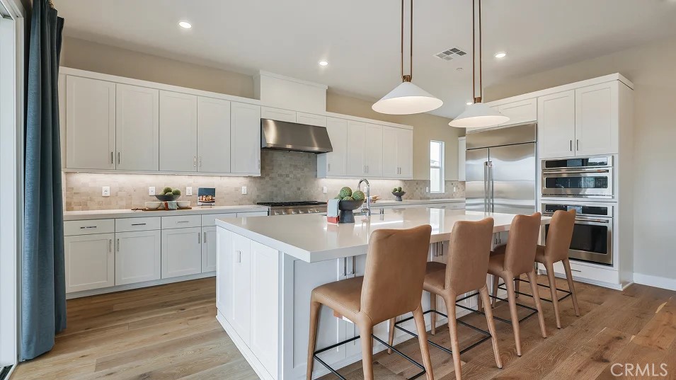 This expansive two-story home offers plenty of space with a total of 4 bedrooms with one of the bedrooms located downstairs with its own private bathroom. The first floor also offers flex space. The rest of the first floor features an open layout from the modern kitchen that offers white cabinetry throughout, massive walk in pantry. The family room opens to a covered California Room ideal for indoor-outdoor living. The second floor hosts a laundry room along with three more bedrooms and a bonus room. The luxe owner's suite has a large walk in closet.