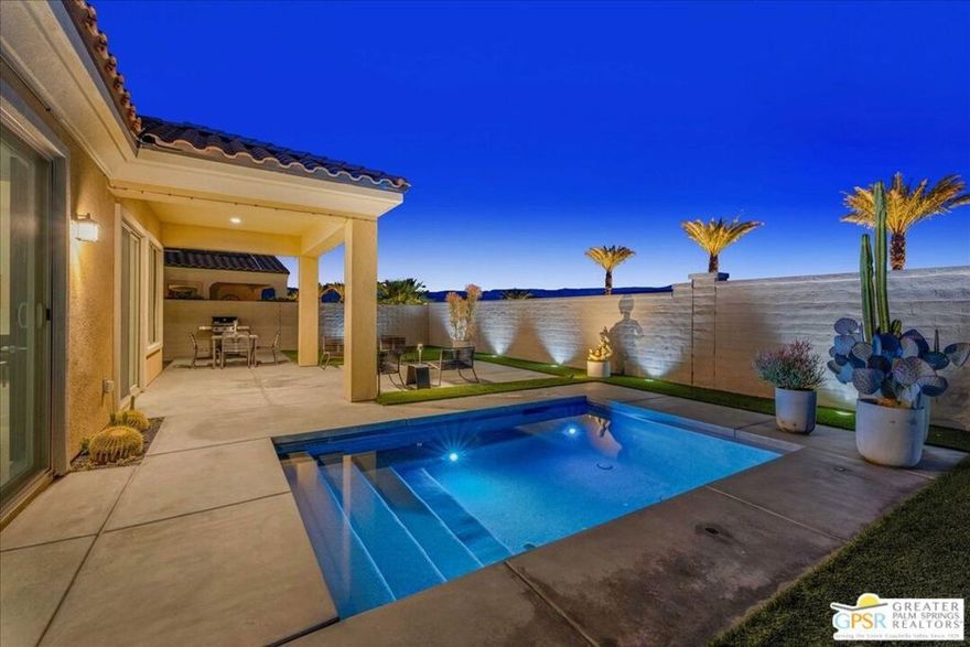 Resort-Style Elegance in Del Webb Rancho Mirage Experience the pinnacle of 55+ active-adult living in this exquisite Phase 4, Plan 2 Solitude residence with a spool, perfectly situated near the clubhouse in one of the community's most serene locations. This sophisticated retreat blends modern comfort with resort-inspired design, offering 2 bedrooms, 2 baths, and a versatile den - ideal for a home office, creative studio, or quiet reading lounge. The open-concept layout creates a seamless flow between the living, dining, and kitchen areas, framed by expansive windows that showcase breathtaking views of the Shadow Mountains. The chef's kitchen impresses with a sleek quartz island and countertops, upgraded 42" upper cabinetry, high-end gas cooktop, stainless steel appliances, and a spacious pantry - perfect for entertaining in effortless style. The primary suite is a private sanctuary featuring direct access to the spool area, a spa-like ensuite with dual vanities, a glass-enclosed shower, and an oversized walk-in closet. The secondary bedroom, thoughtfully positioned for privacy, offers a welcoming space for guests. Throughout the home, designer details shine - from polished porcelain tile flooring to bold black lacquer accents and multiple builder upgrades that elevate every room. Step outside to your own private desert oasis. The beautifully designed backyard features a lush faux lawn, striking hardscape with a built-in gas fire pit, and a glimmering spool with spa jets and tranquil water features - an ideal setting to unwind beneath the desert sky. A charming citrus garden adds a refreshing touch of color and fragrance to this exceptional outdoor retreat. Additional highlights include leased solar ($114.51/mo), a two-car attached garage, and a well-appointed laundry room with extra storage. Nestled within the prestigious guard-gated community of Del Webb Rancho Mirage, residents enjoy access to world-class amenities including a clubhouse, resort-style pool and spa, tennis and pickleball courts, state-of-the-art fitness center, putting green, billiards, and miles of scenic walking paths. Truly a must see.