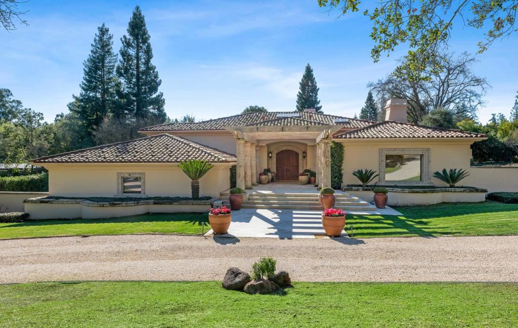 Custom built in 1991, this stunning oasis is nestled on a quiet cul de sac. As you enter a spacious foyer, the open living & dining room extends to the outdoors w/walls of sliding glass. The loggia beyond features a seating area w/fireplace & dining area flanked by overhead heaters & is coveted space year-round w/retractable curtain to close off the large patio. The kitchen has a grand center island w/prep sink & warming drawer, & an adjacent family room. The primary ensuite has a fireplace, seating area, 2 walk-in closets, 2 wall closets, & a separate workout room opening to the backyard for fresh air. There's also a bonus room for many options. The guest house has a living room w/fireplace, full kitchen w/dining, a bedroom & bathroom. A nice feature is its own patio w/dining area. Other conveniences: Wine closet, wet bar off the dining area, 2 coat closets, tons of storage, skylights galore. The grounds are spectacular on a level lot w/gorgeous roses & Italian pottery.