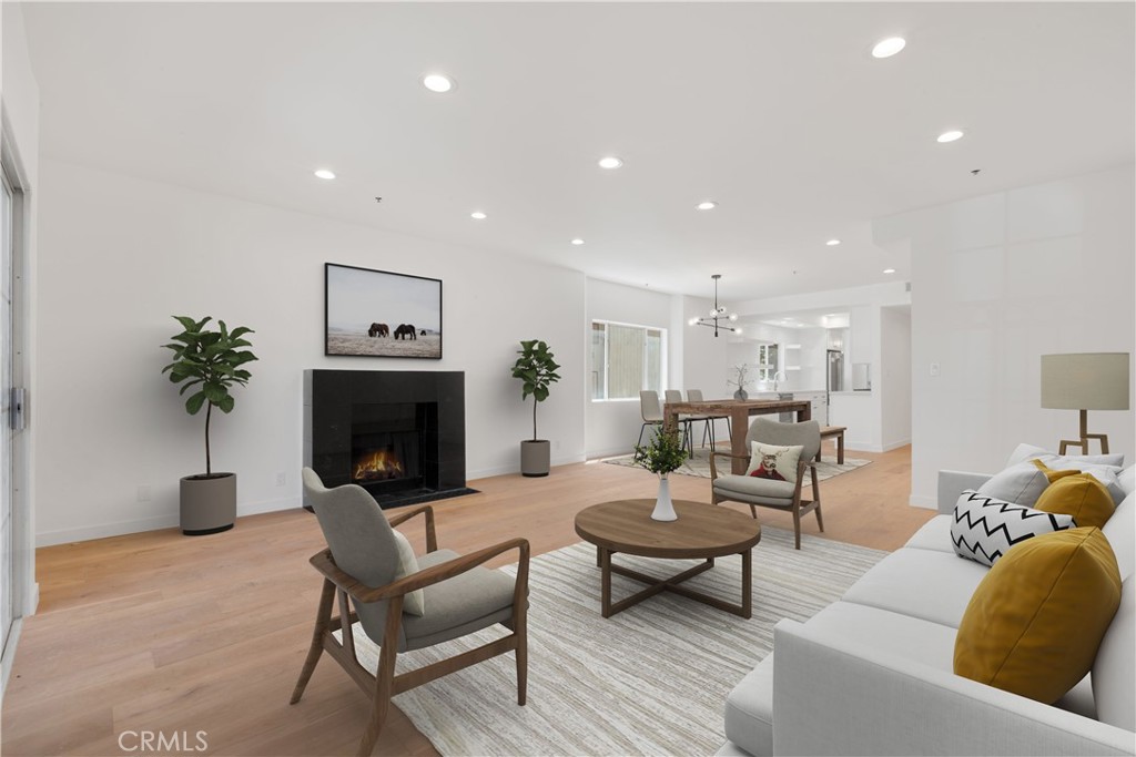 Stunning Remodeled Condo situated in truly one of the best locations! The owner spared no expense tastefully remodeling this modern end unit that spans the length of the building creating privacy and extra windows providing tons of natural light! The open floor plan offers a fabulous living room with recessed lights & cozy fireplace leading to a large balcony! Amazing gourmet chef's kitchen w/ newer stainless appliances! Gorgeous primary suite w/private bath featuring a freestanding soaking tub, dual sinks and beautiful marble design! Large dual closets and French doors leading to a private patio w/ access to garage! Custom built-in workspace for those who like to work from home! Personal washer/dryer in unit! Newer HVAC system! Perfect location just steps away from dining, theater, UCLA, Westwood, Westfield Shopping Mall, Sawtelle Blvd and much more!!!!