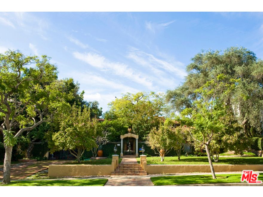 A PRIVATE & SEQUESTERED RALPH FLEWELLING AIA, COURTYARD SPANISH. 1929 walled & gated villa has all the classic elements of a pure & timeless Beverly Hills Estate. Featuring a dramatic living room with stone fireplace & high beamed ceilings,  Library with fireplace, formal dining w/ beamedceilings, kitchen adjacent to family room along w/ junior dining room, Master bedroom has a FP, patio, and a huge ensuite bath & closet. 2 additional  bedroom suites up -  maids/office down, Outdoor dining area & living room complete with fireplace and built-in banquets, exterior kitchen/bar area, lap pool, spa and 2 fully self contained guest houses Double garage w/ adjacent gated carport. So much to this property one has to see to fully experience. All principle rooms, both front and back access the gorgeous gardens, This a well scaled house that was updated & expanded in the early 1990's - it's time for another, but perfect for those looking to create their own world w/ ultimate privacy & location.