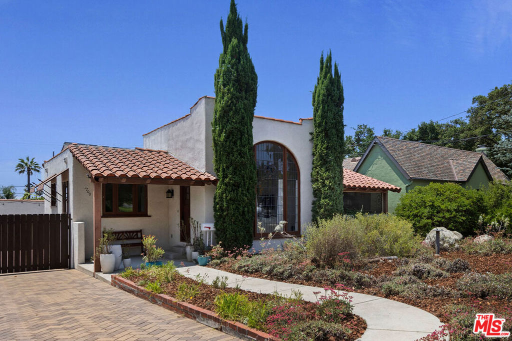 This furnished 1927 Spanish is available for lease on a peaceful Altadena street, offering vintage charm and a dreamy backyard. The living room features soaring ceilings, a stunning arched window, and a tile fireplace; a bonus room off the main space is perfect for an office or reading nook. The kitchen has updated appliances, plenty of storage, and a large walk-in pantry. Three bedrooms include a sunny ensuite primary; the front bedroom opens to a private patio. The grassy backyard feels expansive and private, with a pergola-covered area for lounging. Amenities include central AC/Heat, laundry, and a two-car garage plus a long driveway for additional parking. Enjoy nearby hiking trails and local favorites Prime Pizza, Millie's Cafe, Woon, and everything else Altadena and nearby Old Town Pasadena have to offer.