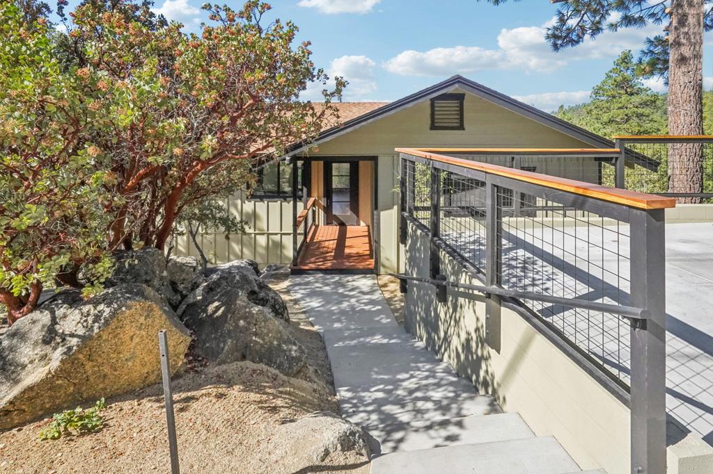 Freshly renovated and move-in ready, this 3-bedroom, 2-bath home offers 1,565 sq ft of stylish mountain living on a spacious 0.40-acre lot with rare street-to-street access. Enjoy peace of mind with a fully fenced yard, certified septic, marked property corners, and completed termite work.Step inside to discover brand new flooring, a modern kitchen, updated bathrooms, and sleek recessed lighting throughout. Tongue and groove ceilings, new doors and windows, and an upgraded electric panel add comfort and character. Parking is a breeze with a generous parking pad.The main floor welcomes you with an open-concept living area, two bedrooms, a large full bath, and a sunny deck perfect for taking in valley and mountain views. Downstairs, the private primary suite features a walk-in closet and direct access to a second deck and the backyard. You'll also find a separate laundry room and a spacious bonus room-ideal for a home office, media room, or even a fourth bedroom.With fresh finishes, flexible spaces, and sweeping views from both decks, this home is the perfect retreat for anyone seeking comfort, convenience, and a true mountain lifestyle.