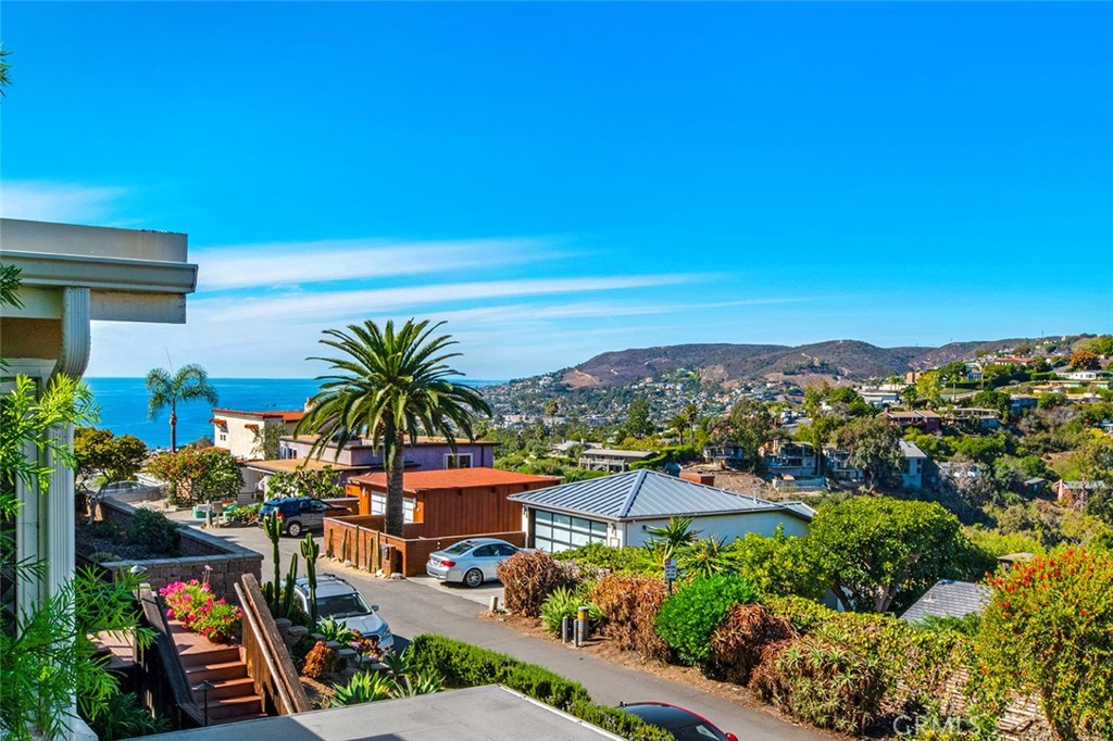 Move right in to this gorgeous Victorian 5 BR 3 BA home with panoramic views from the city lights to the Pacific Ocean located on a cul de sac above Laguna Village in Summit Ridge. This custom home has been recently remodeled in Modern Farmhouse style including 5 separate decks, vaulted ceilings, lots of natural light, spacious rooms, large kitchen open to the great room and neutral fresh paint colors throughout. The lower level includes a 2 car garage with storage. The main level greets you with a large viewing deck for outdoor dining/lounging/entertaining, container gardening and peaceful ocean breezes and views. The large gourmet kitchen features quartz counters, stainless steel appliances and sink, lots of storage and counter space. It is open to the dining room including built in storage, open to the large great room with a dry bar, stone surround fireplace and more views. There are two bedrooms and one bath on this main level with views to the ocean in the front, and the beautiful garden in the back of the home. Upstairs you will find the large master suite including large picture windows to capture the ocean view, fireplace, retreat/seating area, and outdoor deck to enjoy your morning coffee or evening glass of wine. The master bath features dual vanity sink, large soaking tub, shower and walk in closet. The 4th and 5th bedrooms and 3rd bath complete the upper rooms again, with ocean and garden views. Laundry utility closet conveniently located on this level. The backyard is beautifully landscaped with multiple outdoor cozy dining areas. Prime location only blocks to the best shopping, restaurants, galleries, and world-renowned beaches that Laguna Beach has to offer! Available for flexible short-term lease, fully furnished including quality newer furnishings, linens, and all items needed to move right in.