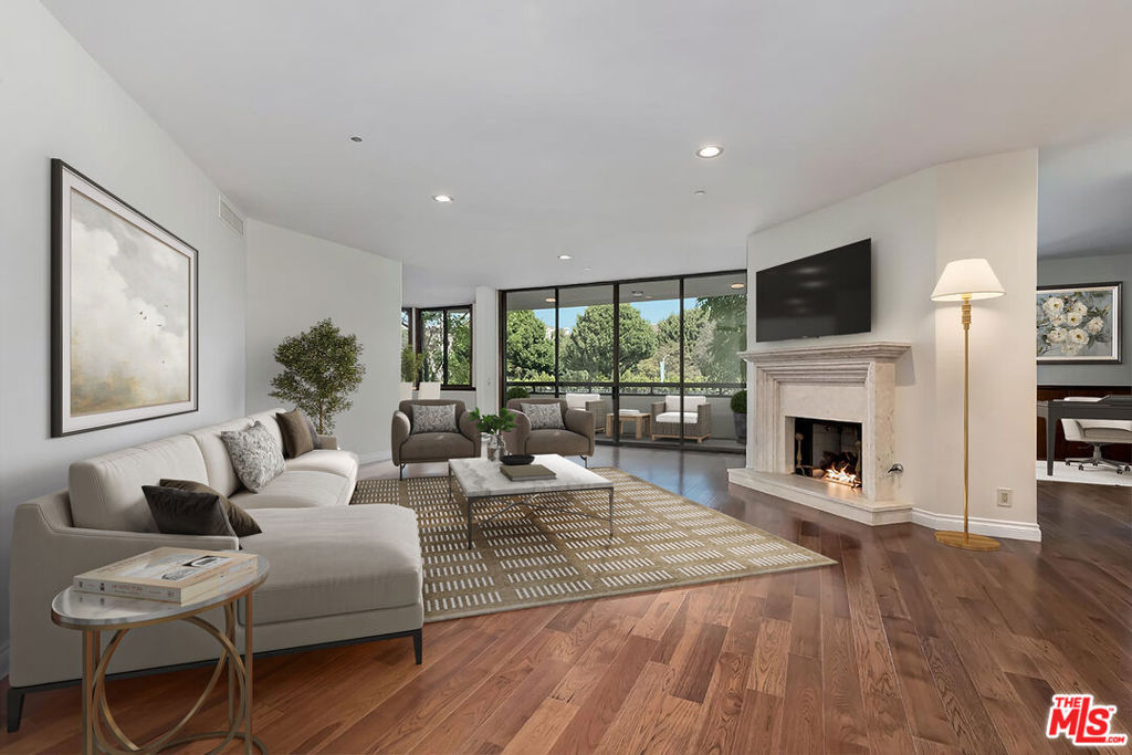 The Deal of the Year! Absolutely phenomenal value (lowest-listed price per foot in years) for this fabulous updated unit located on the 2nd level of the coveted low-rise IV Seasons Condominiums featuring high ceilings, walls of glass, newer gleaming wood floors (no carpets), a large balcony, and substantial patio space. Sleek newer cook's kitchen with large breakfast area and fantastic storage. Great room with fireplace and balcony access. Separate big paneled den with wet bar. Huge primary bedroom suite with 4 closets (two are walk-ins), elegant bath, and patio access. Full-service building with 24 hour valet (residents and guests), security, concierge, gym, sauna, pool, spa, and solid extra storage. Newly and exquisitely renovated reception areas and hallways add to the appeal of this already prestigious building which is proximate to all of the finest Westside amenities.